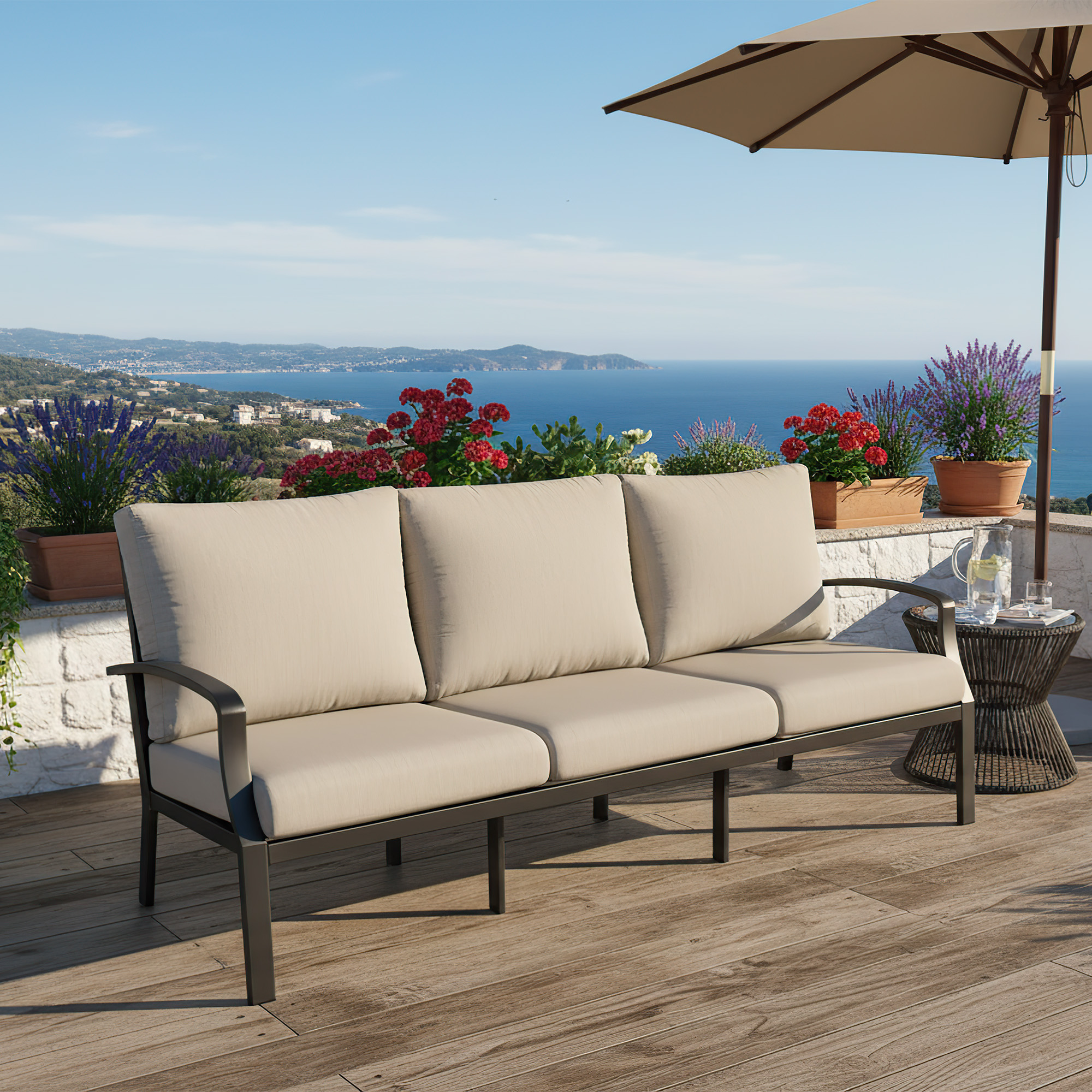 Spacious outdoor patio sofa with beige cushions set on a wooden deck overlooking the sea -Seehill