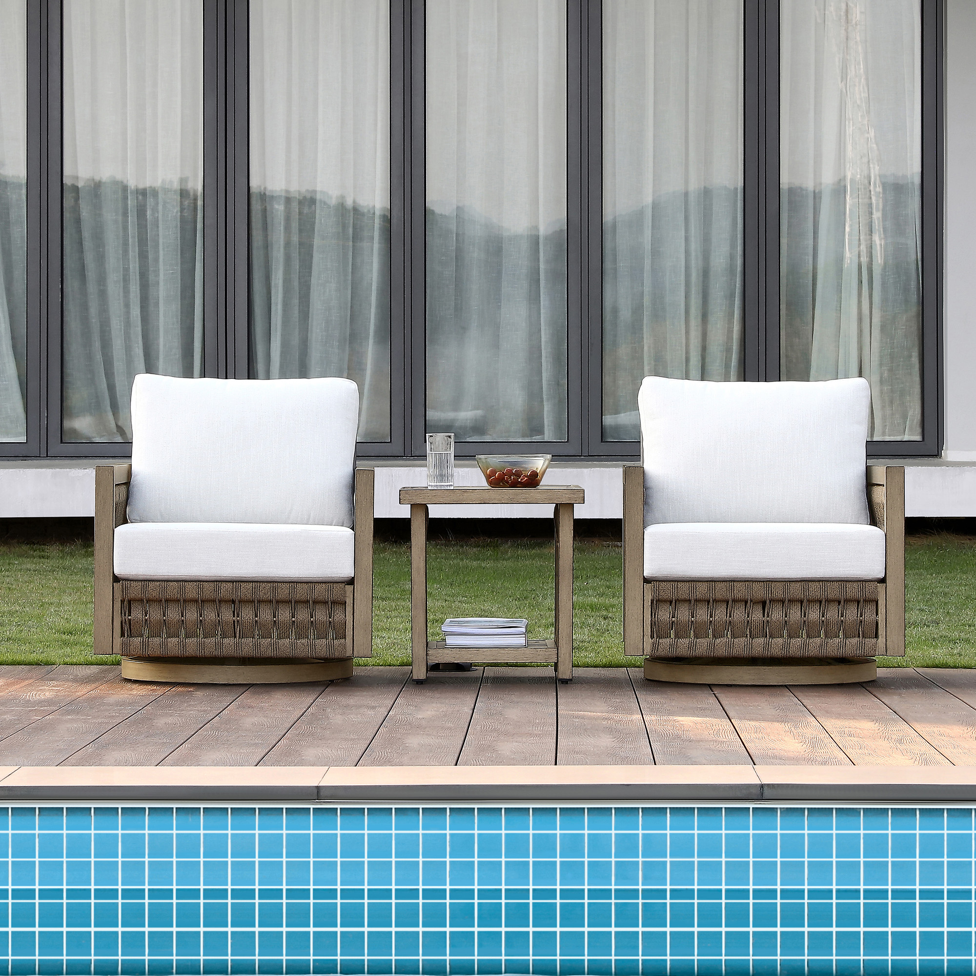 Crafted with outdoor wicker chairs with white cushions by the poolside, this outdoor patio conversation set offers relaxation and style. - Seehill