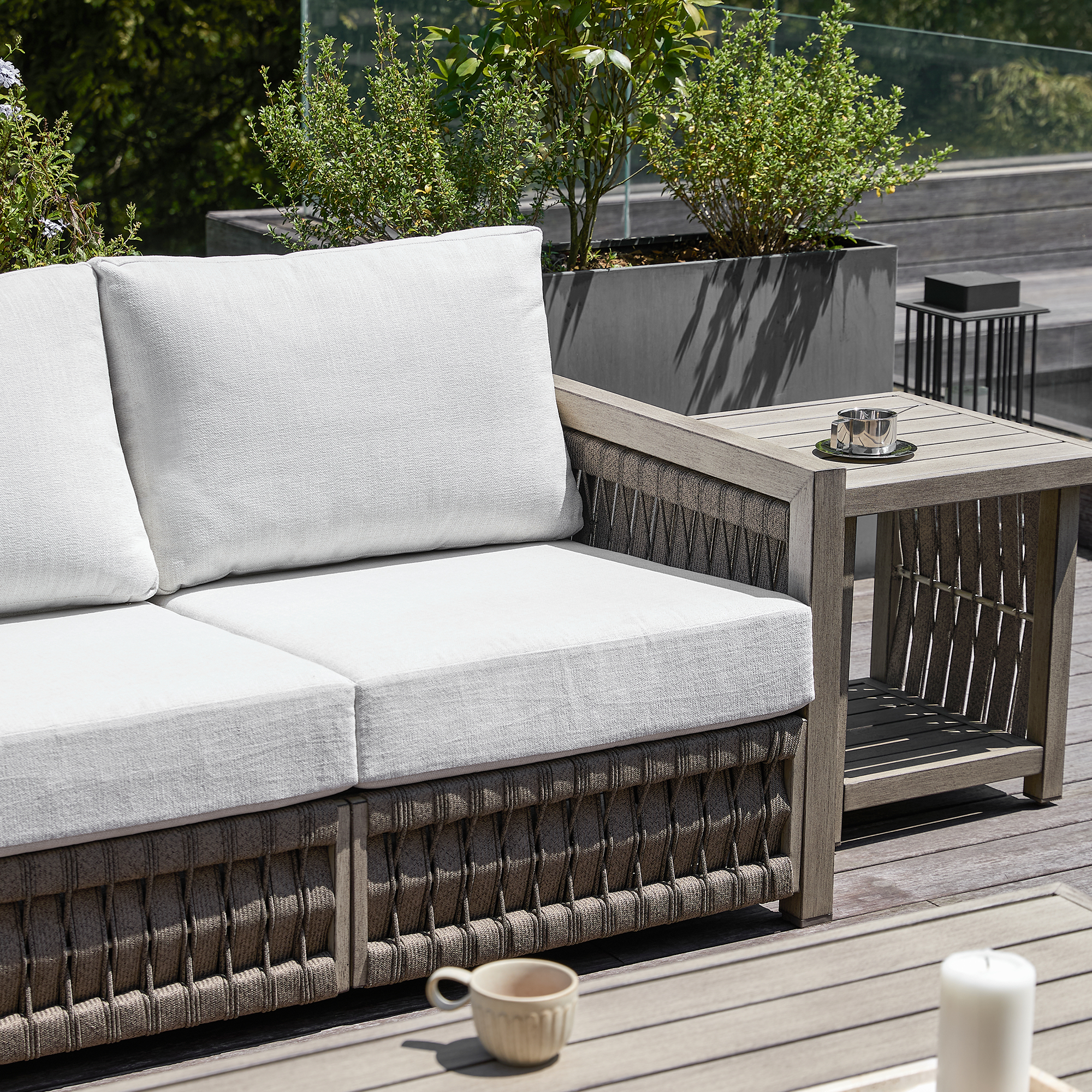 Crafted with outdoor wicker, this sofa features light gray cushions and a side table, forming this Seater Outdoor Patio set. - Seehill