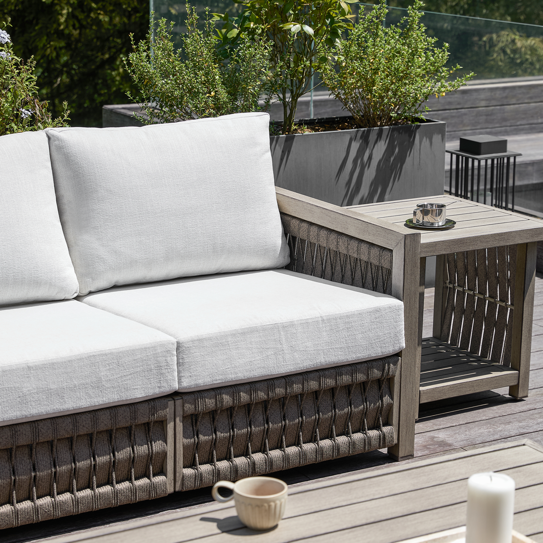 Outdoor wicker sofa with light gray cushions and side table - Seehill