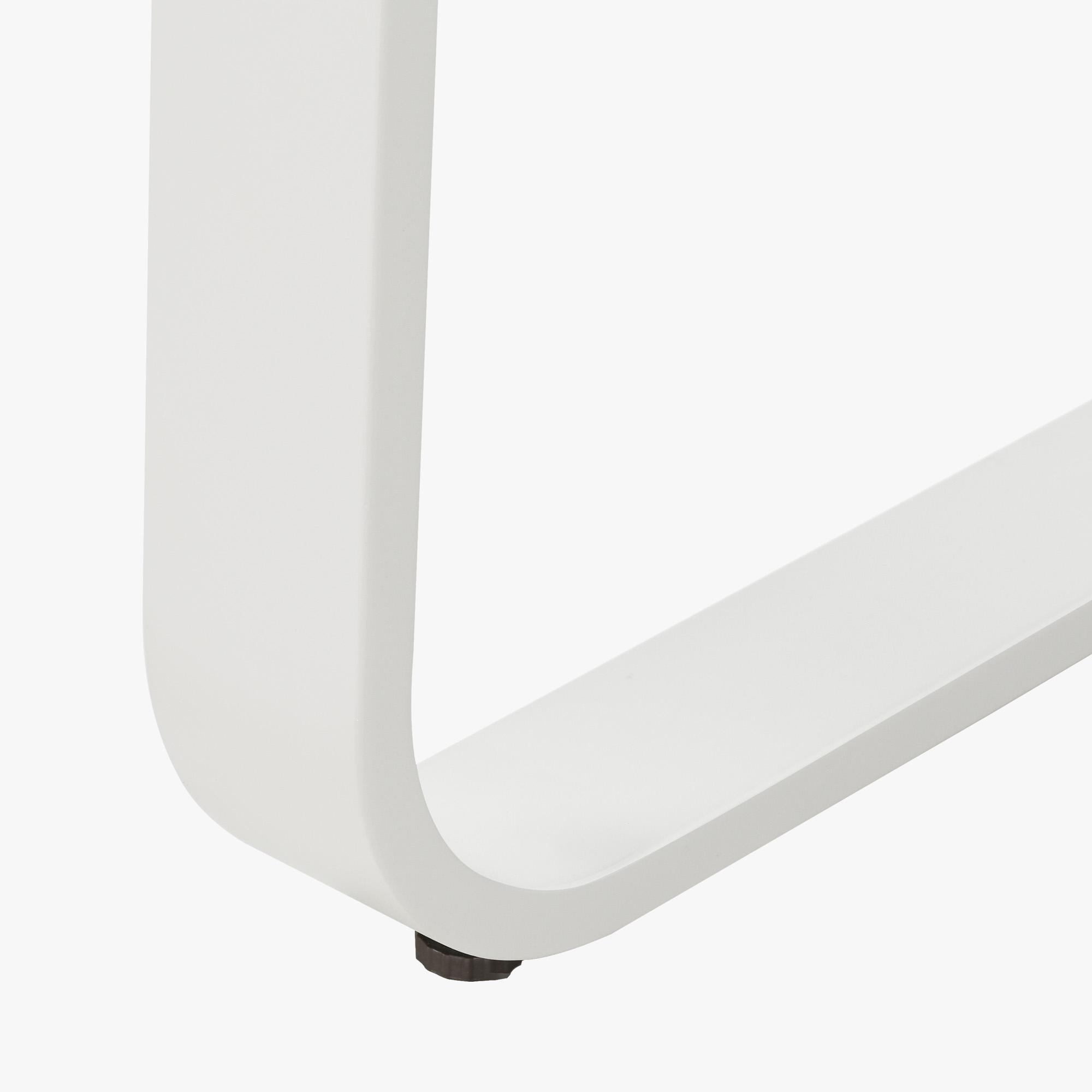 Close-up of white metal U-shaped leg with adjustable foot on outdoor dining table -Seehill