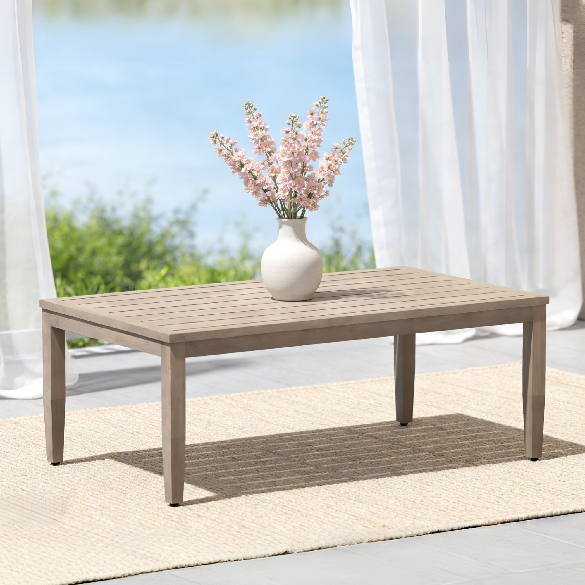 Outdoor patio coffee table with faux wood grain finish and vase of flowers on top-Seehill