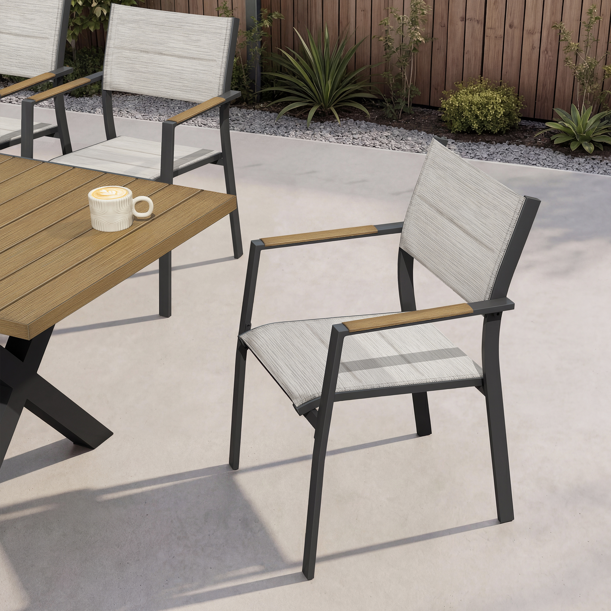 Outdoor dining set with stackable chairs featuring light fabric and wood accents on patio-Seehill