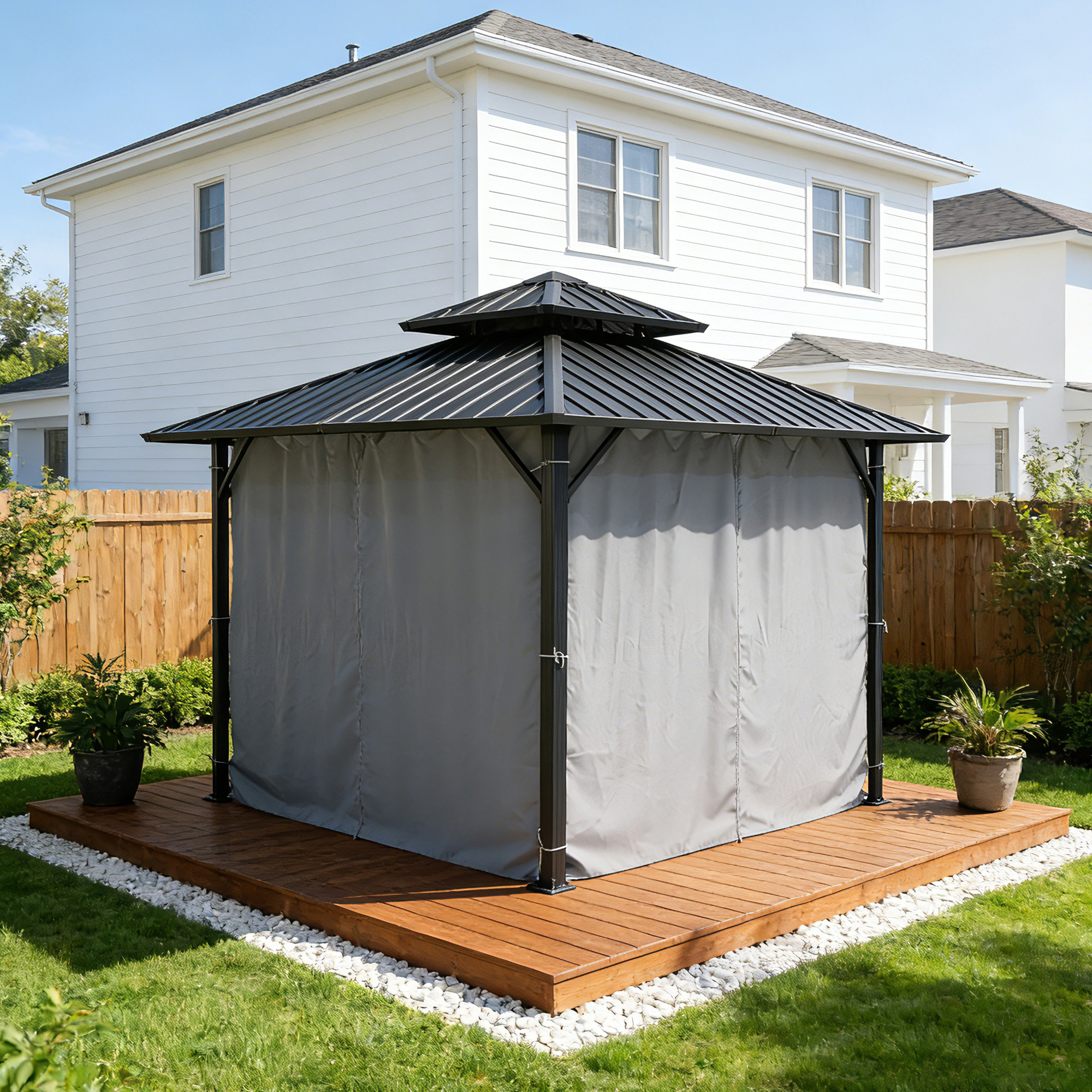 Black metal hardtop gazebo with gray curtains on wooden deck in backyard setting -Seehill