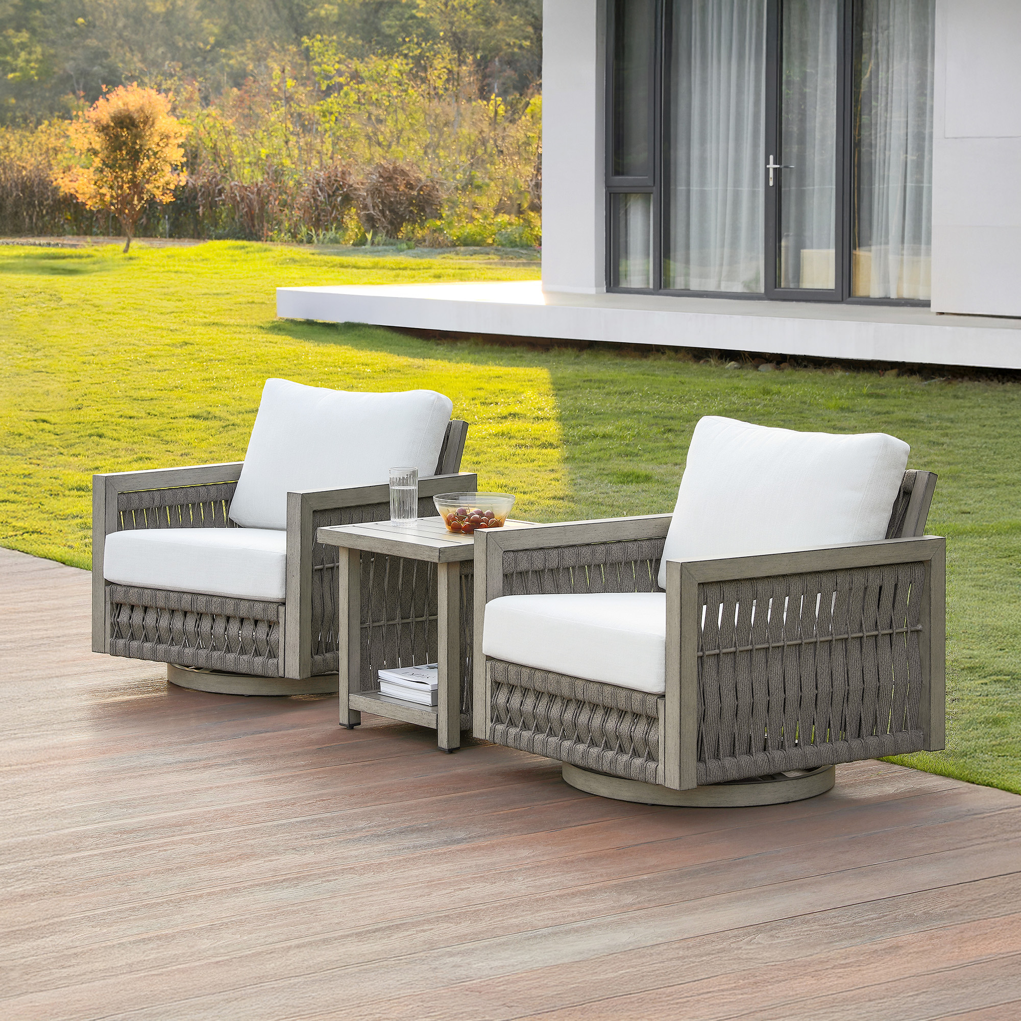 Highlighting the gray woven outdoor swivel chairs with white cushions of this refined outdoor patio. - Seehill