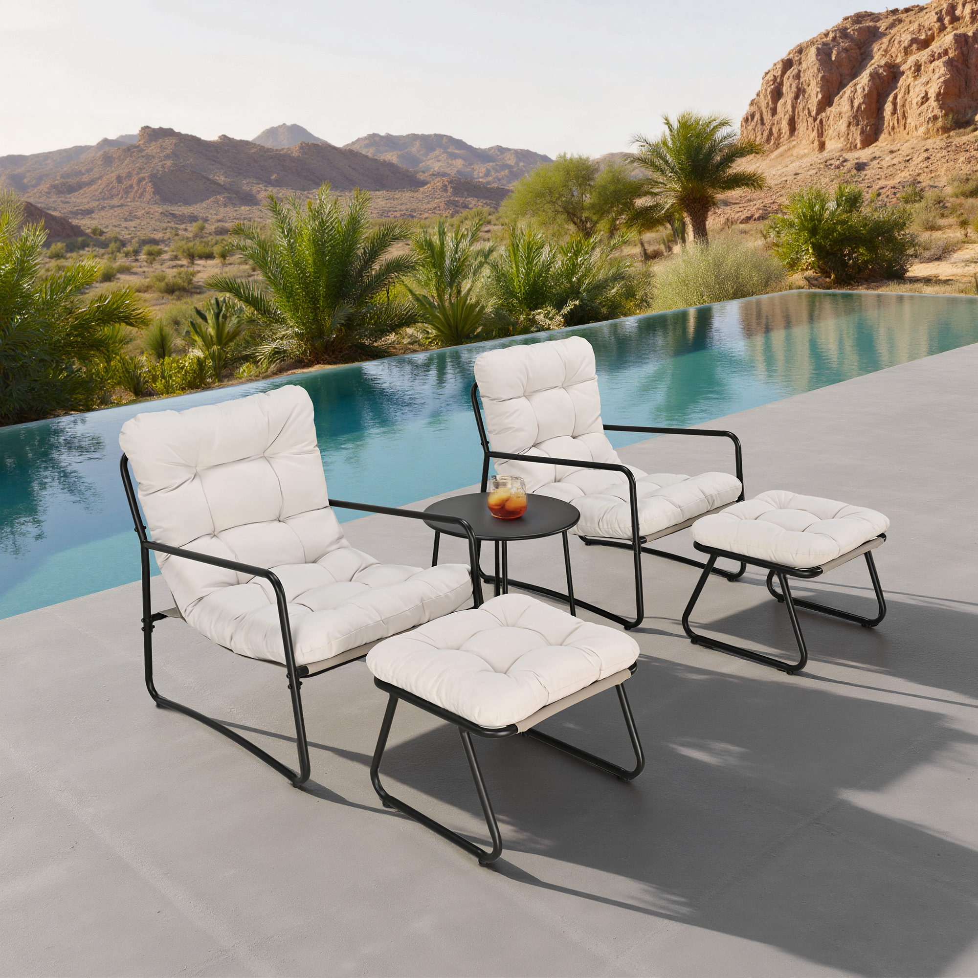 Two cushioned metal rocking chairs with ottomans and a side table by a pool -Seehill