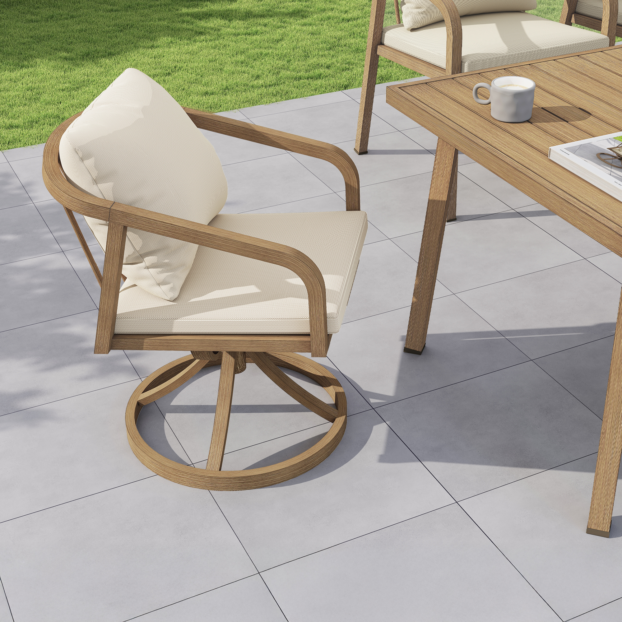 Outdoor patio dining set with cushioned swivel chair on tiled floor near grass-Seehill
