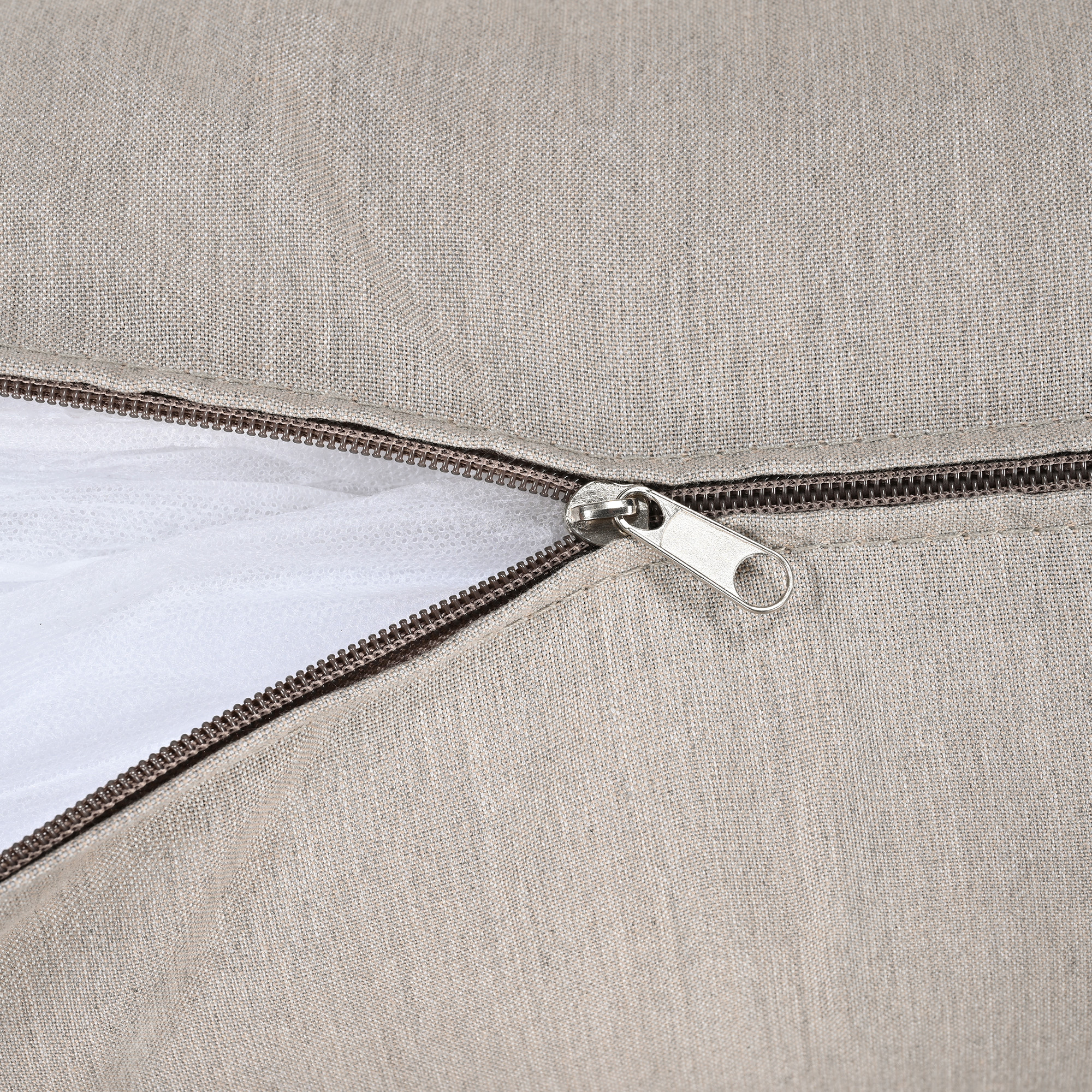 Close-up of beige fabric cushion with a partially opened zipper showing inner lining -Seehill