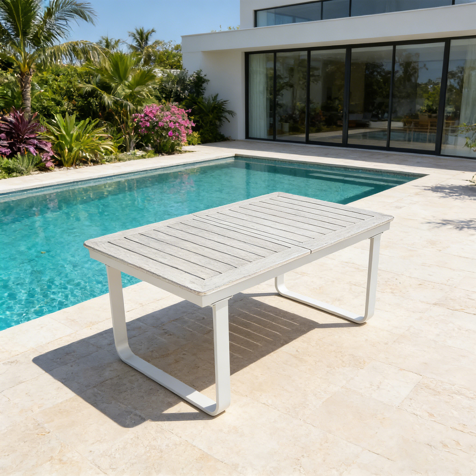 Expandable outdoor dining table with white U-shaped legs by a poolside patio-Seehill