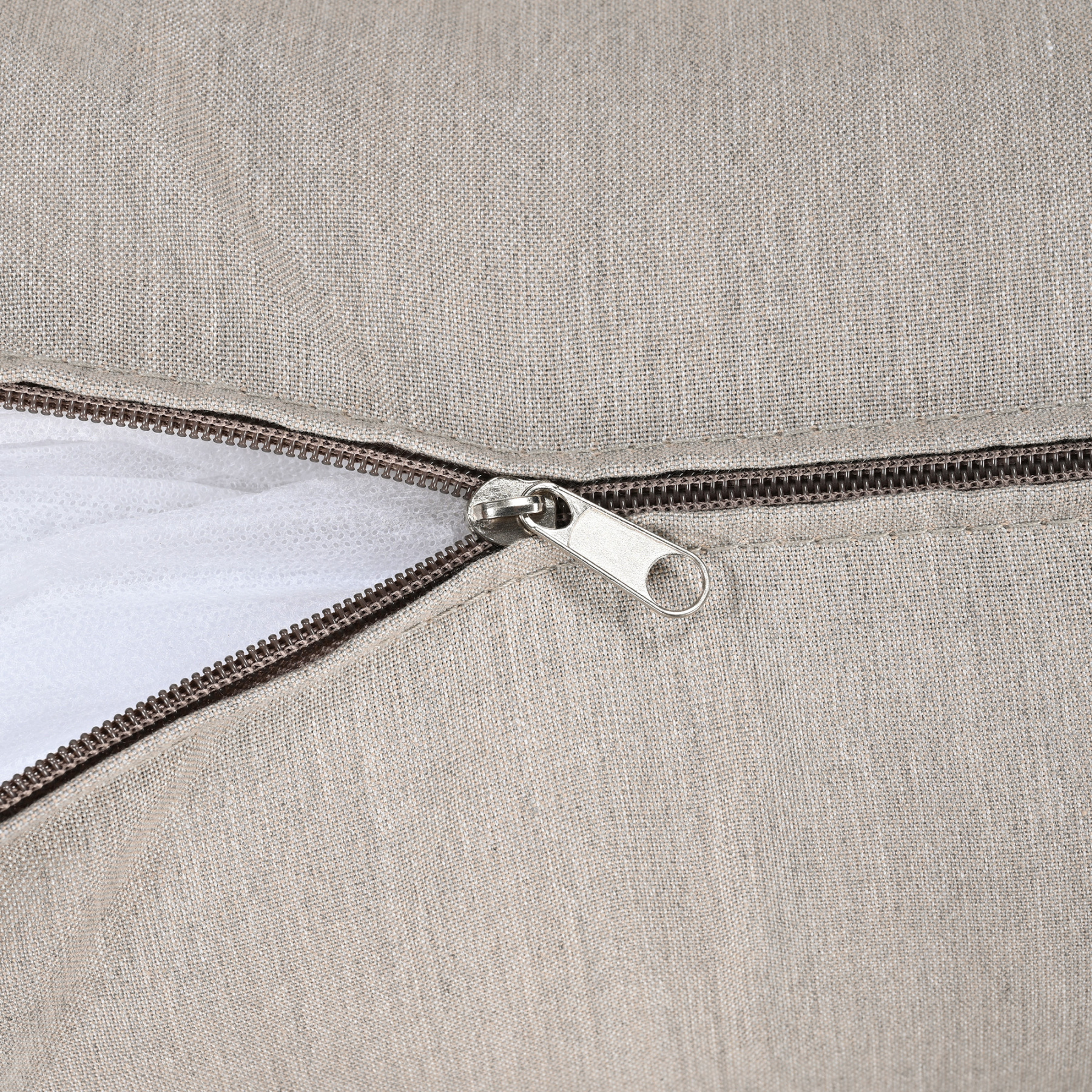 Close-up of a beige fabric cushion cover with a zipper detail for easy removal -Seehill