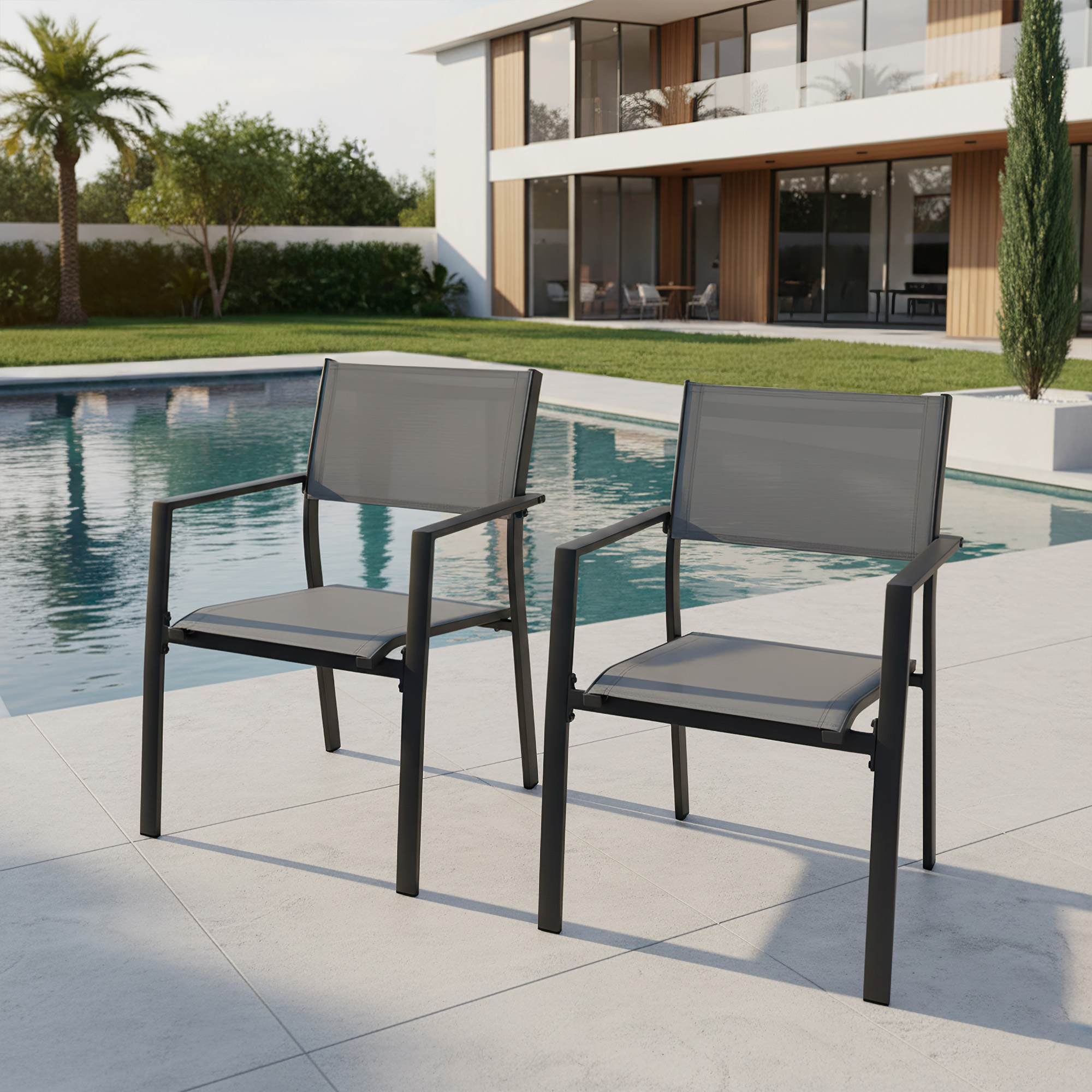 Two stackable patio dining chairs with textile seats and backs by a poolside setting -Seehill