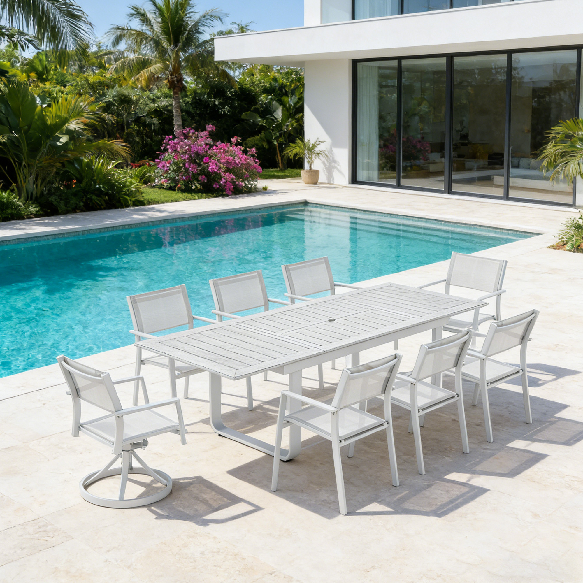 Extendable outdoor dining set with nine white chairs by a poolside patio-Seehill