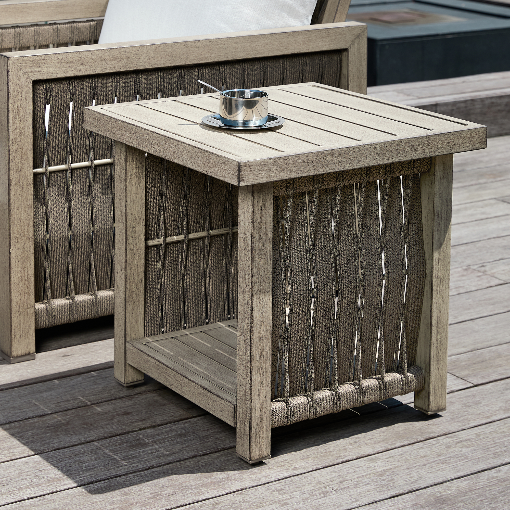 Crafted with outdoor wicker, this side table features a storage shelf and cup holder, complementing the Outdoor Patio set. - Seehill