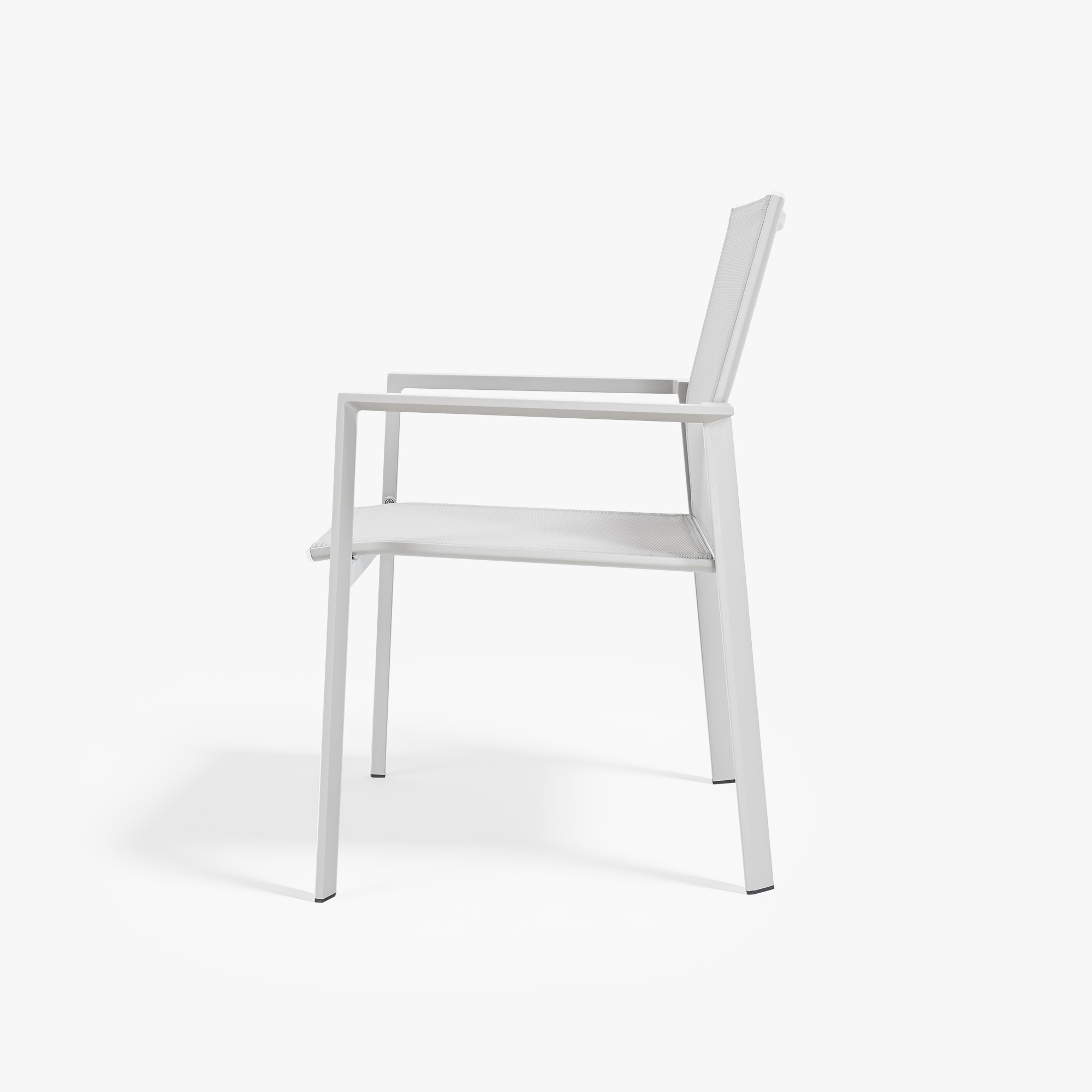 Side view of a white stackable patio dining chair with full woven seat and back-Seehill