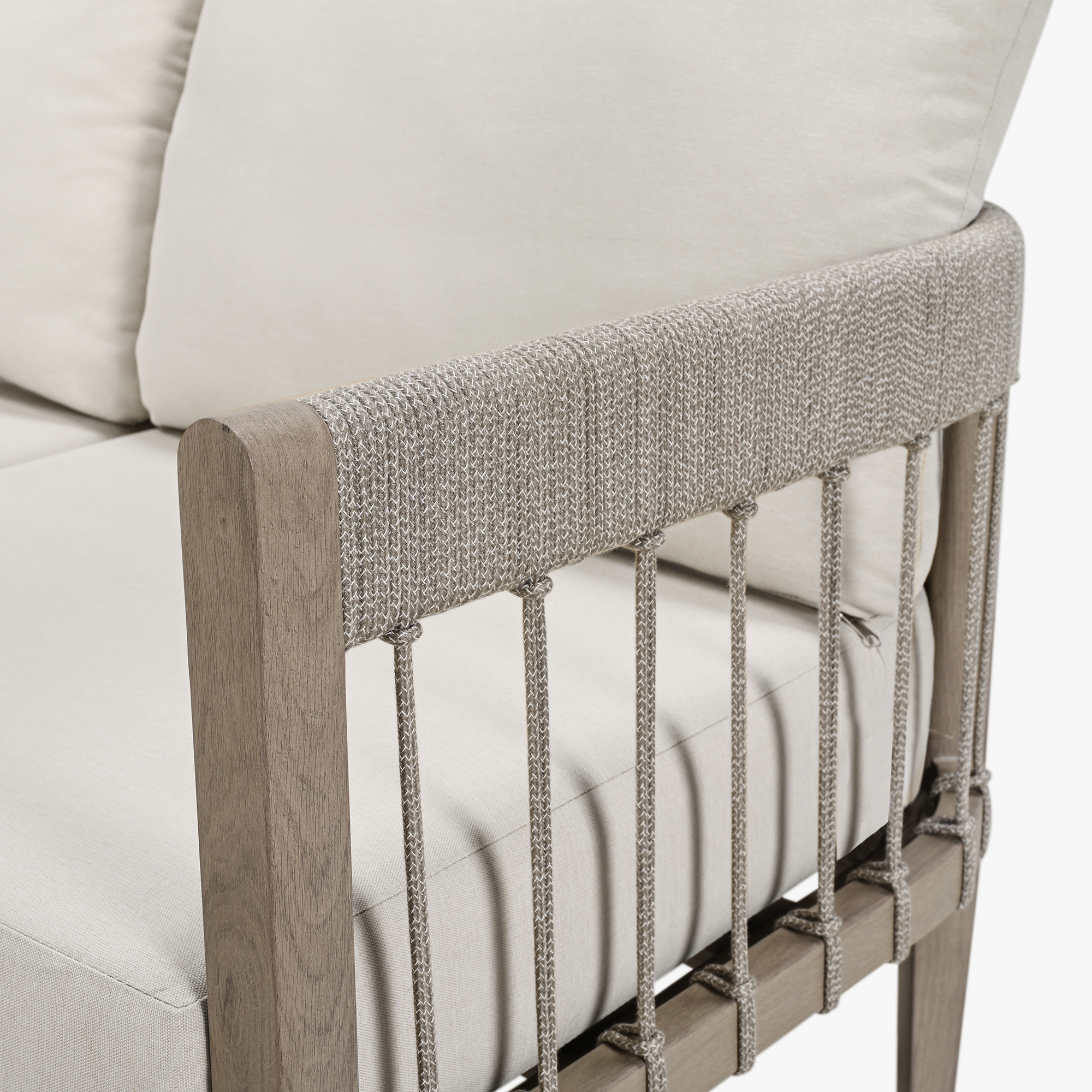 Close-up of patio sofa armrest with woven rope detail and light beige cushions-Seehill