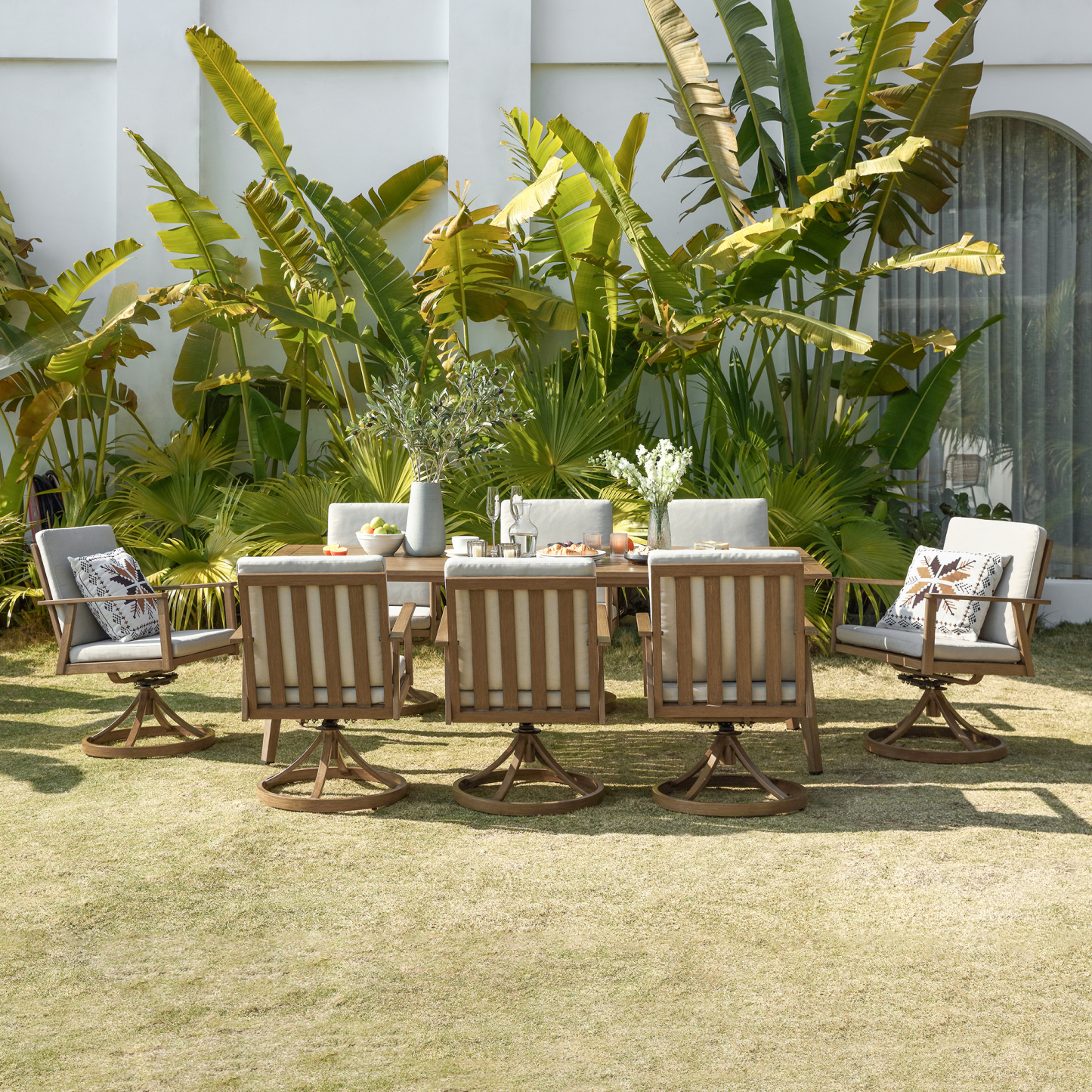 Teak outdoor dining set with swivel chairs, cream cushions - Seehill
