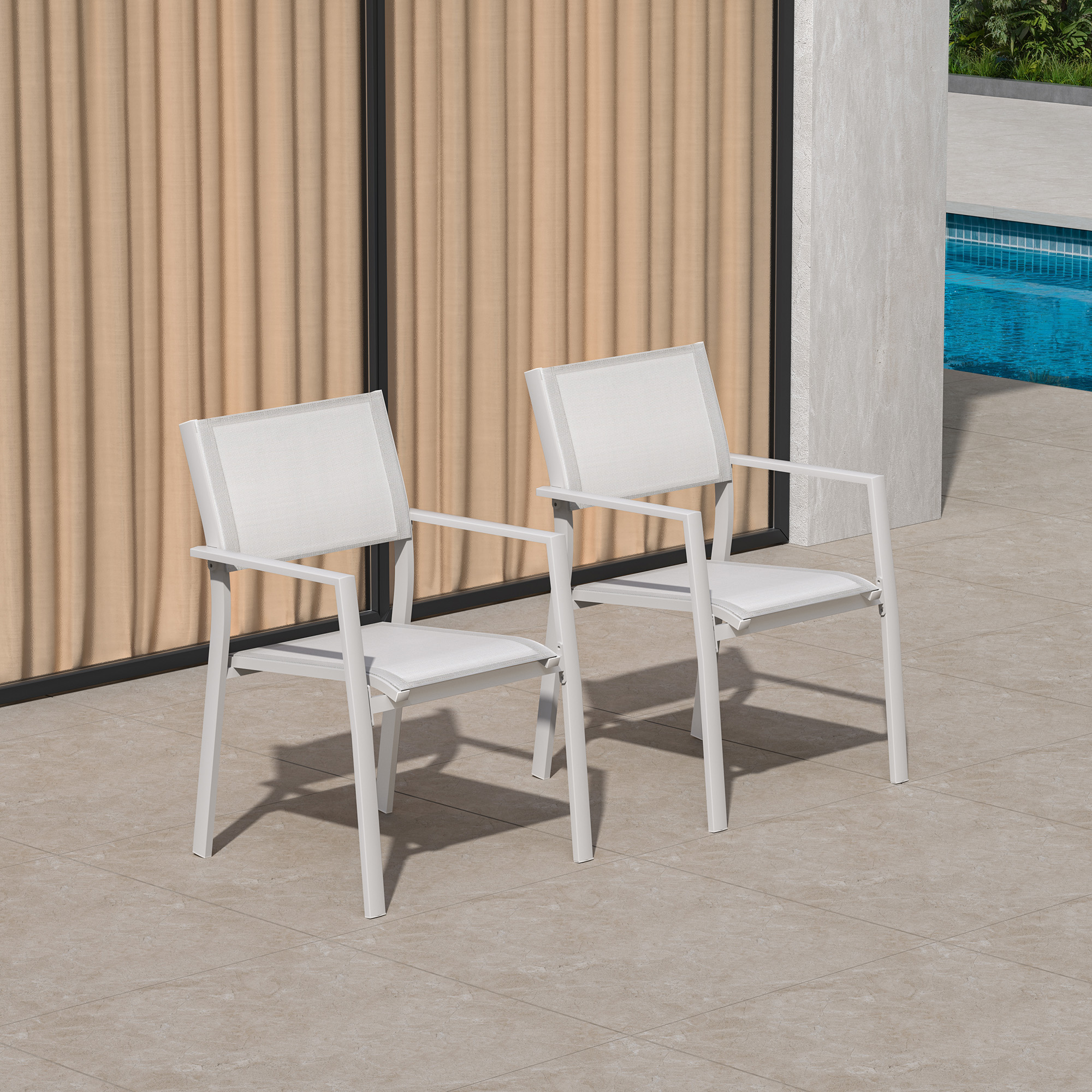 Two white stackable patio dining chairs with textile seats by a poolside setting - Seehill-Seehill