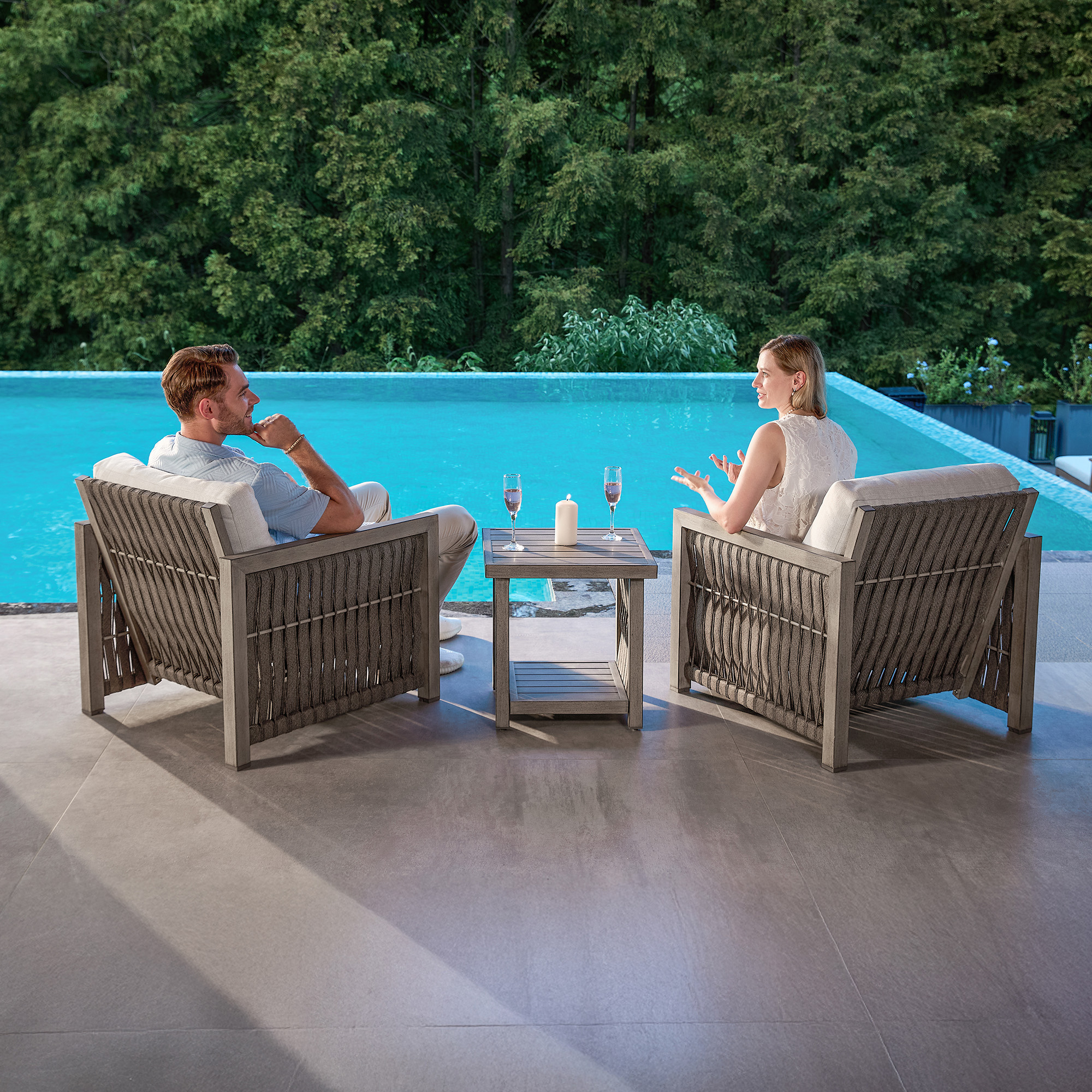Experience the outdoor wicker lounge chairs with side table by the pool in our sophisticated Outdoor Patio set. - Seehill