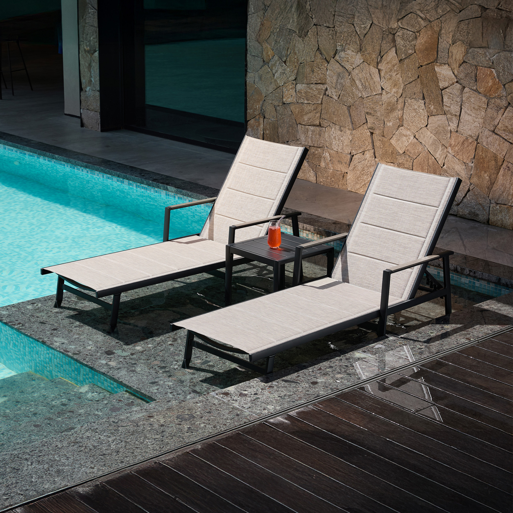 Outdoor lounge chairs with side table by poolside - Seehill