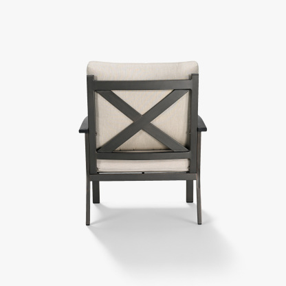 Back view of a cushioned patio armchair with dark metal frame and beige fabric-Seehill