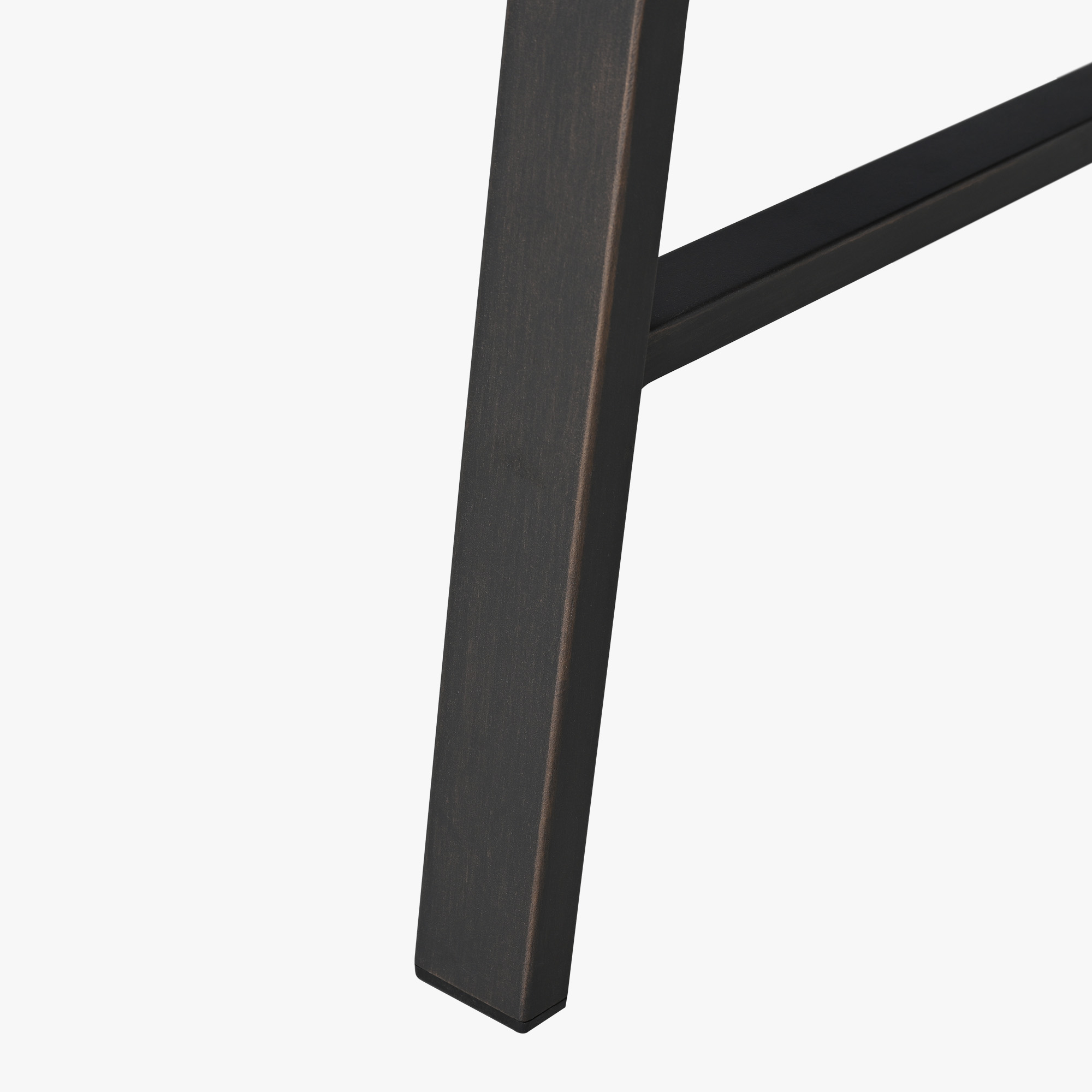 Close-up of a dark metal leg with a crossbar detail on an outdoor patio coffee table-Seehill