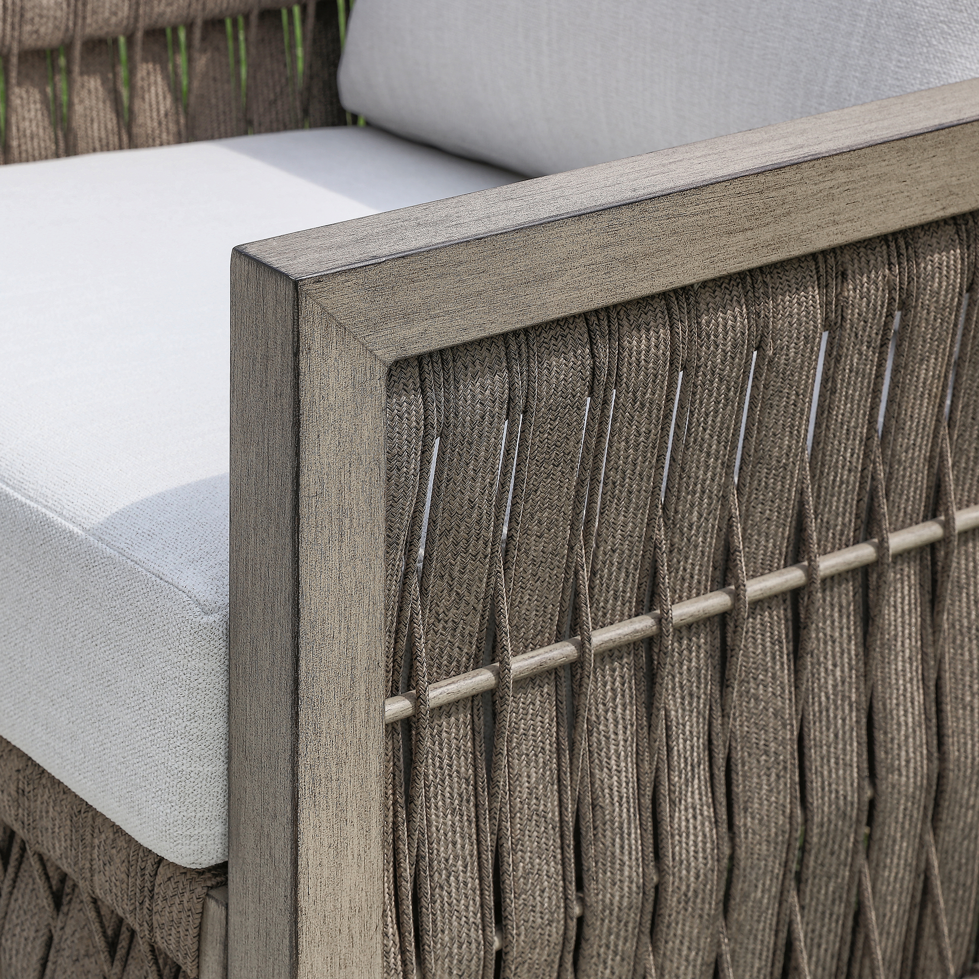 A sophisticated oversize rope weave outdoor swivel sofa features weather-resistant woven rattan construction. - Seehill