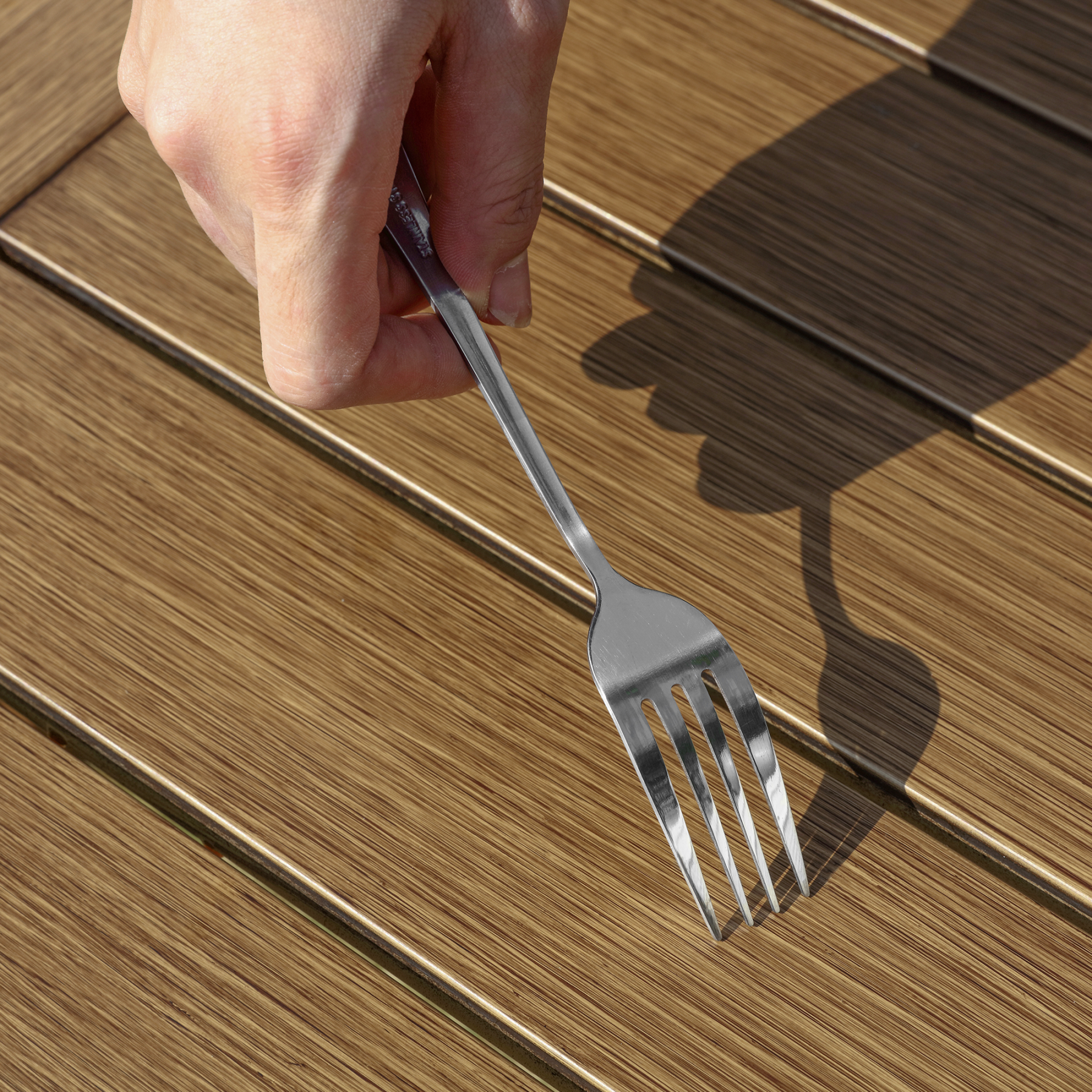 Stainless steel fork with polished finish held  - Seehill