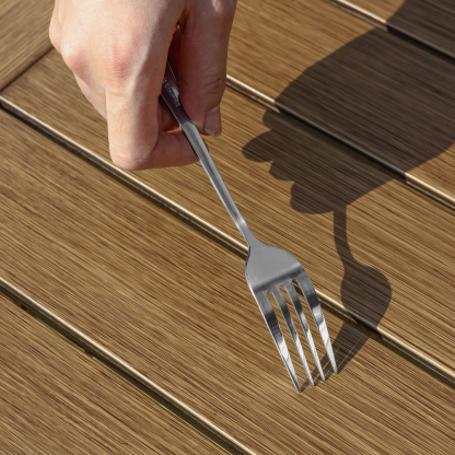 Stainless steel fork with polished finish held  - Seehill