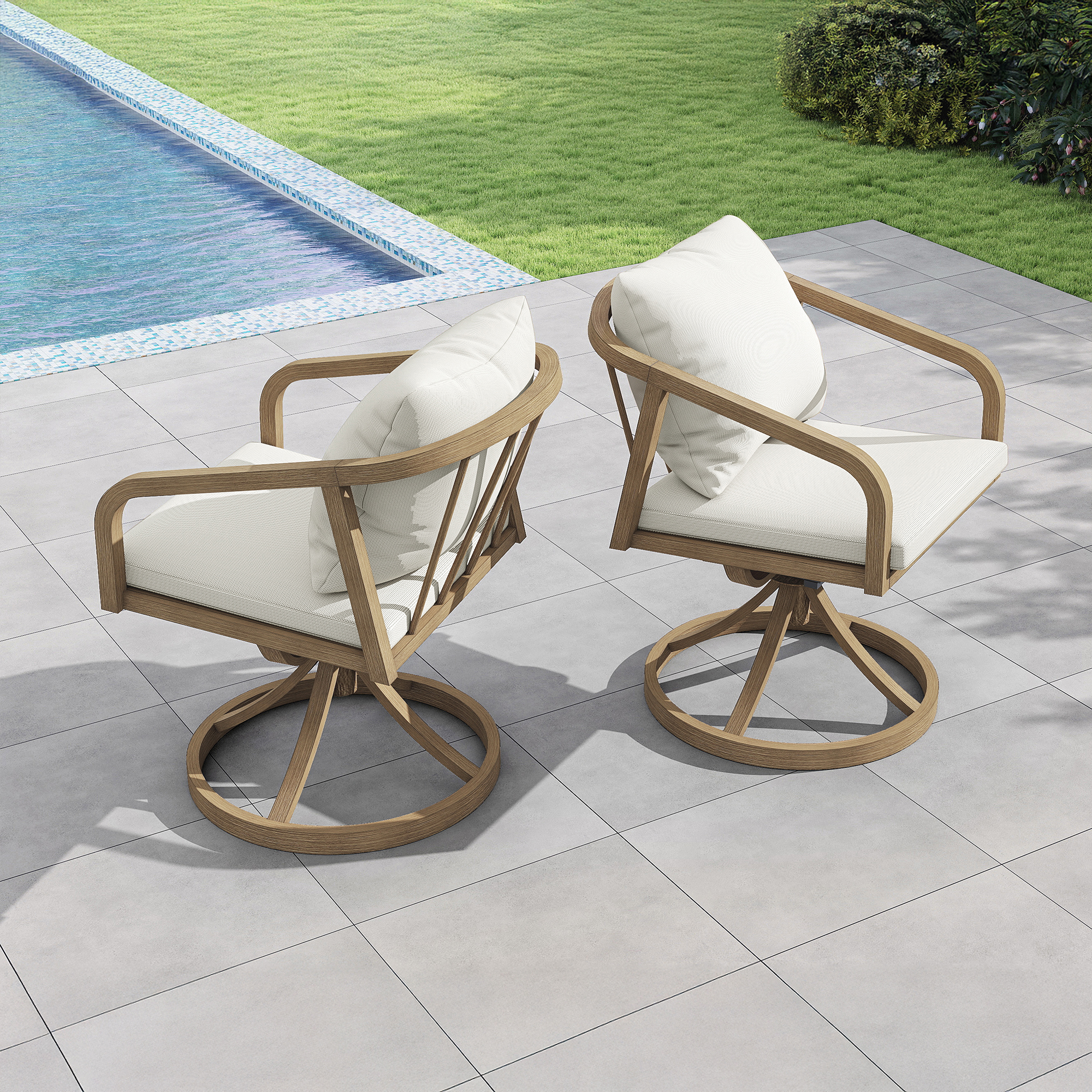 Two outdoor swivel chairs with white cushions set on a patio near a pool and grass-Seehill