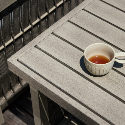 Outdoor wooden table with cup of tea, modern patio furniture - Seehill