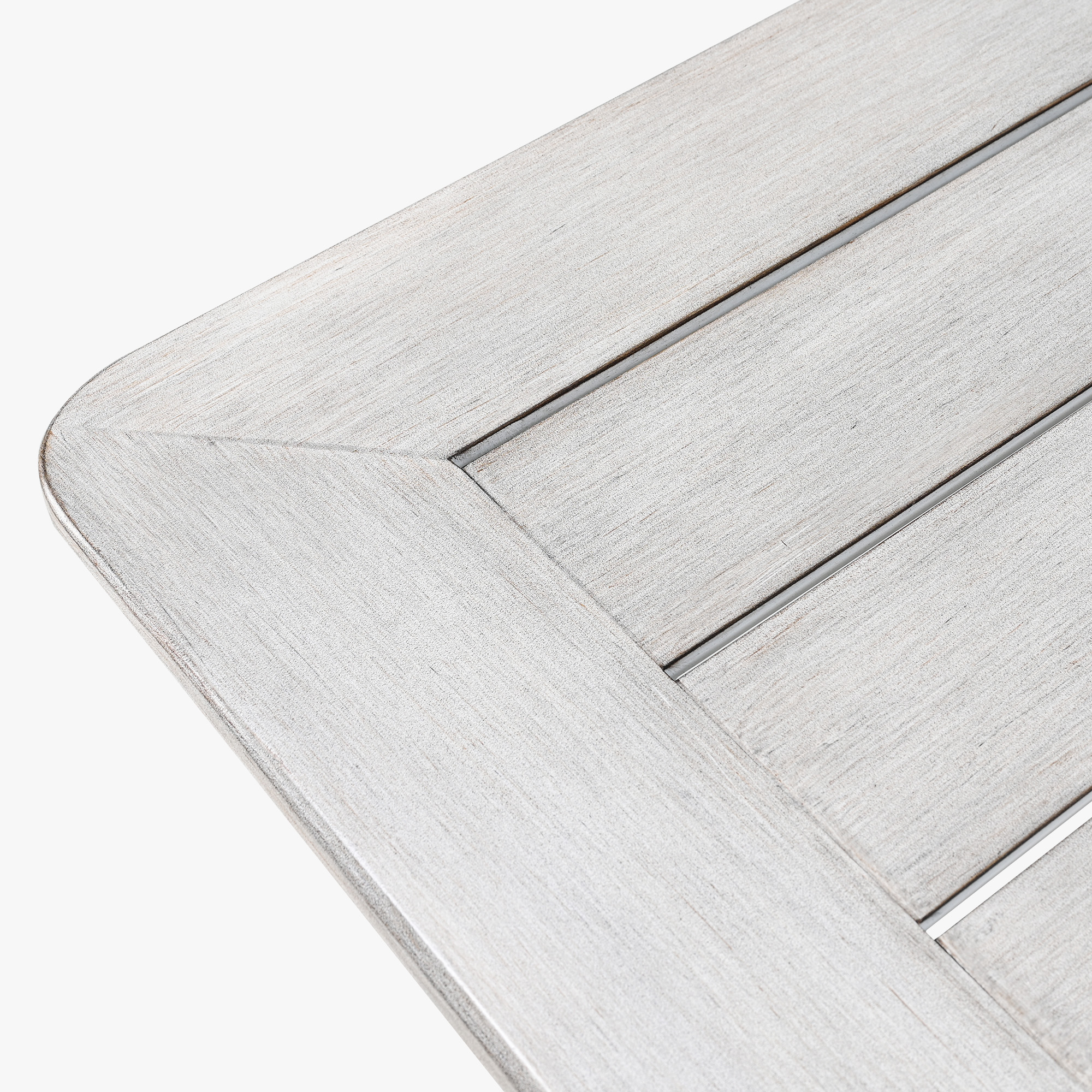 Close-up of the weathered wood texture and corner detail of an outdoor dining table -Seehill