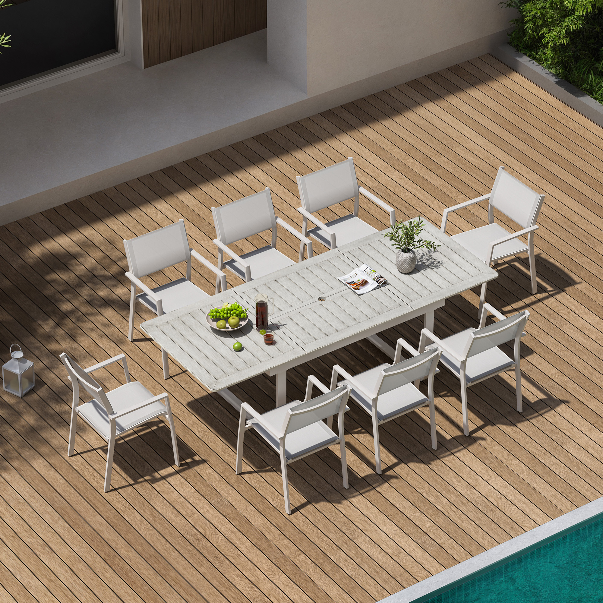 Outdoor extendable dining set with white chairs on wooden deck by pool -Seehill