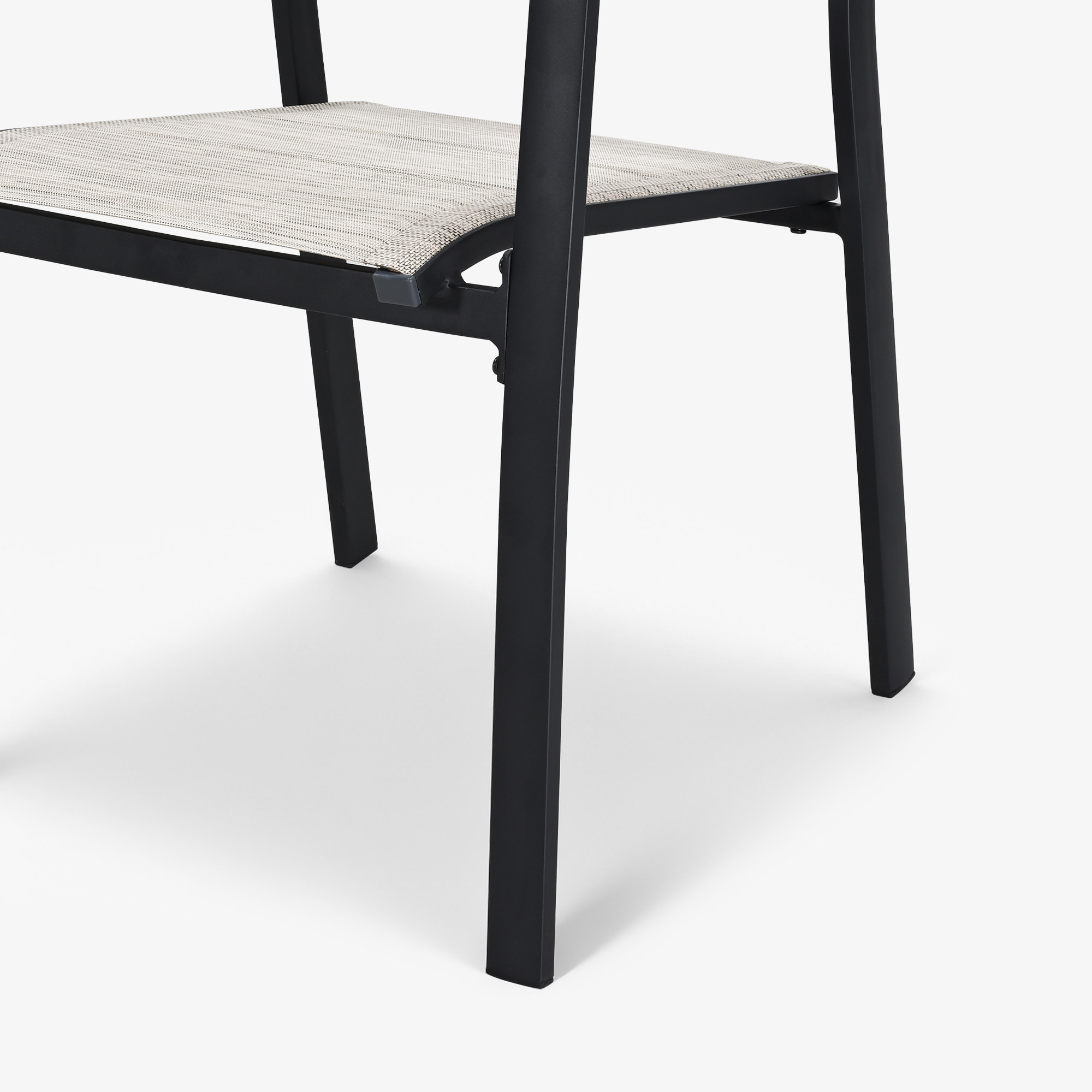 Close-up of black metal leg and woven seat detail of outdoor dining chair-Seehill