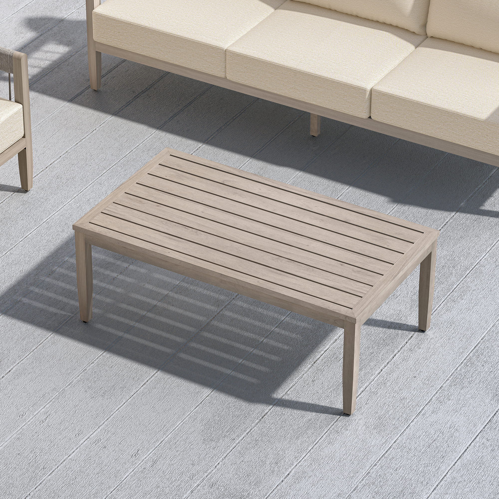 Outdoor patio coffee table with faux wood grain finish beside cushioned seating -Seehill