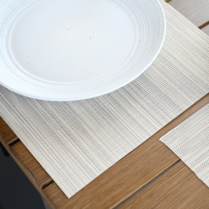 An elegant set of versatile clean look placemats with four beige, woven rectangular placemats. - Seehill
