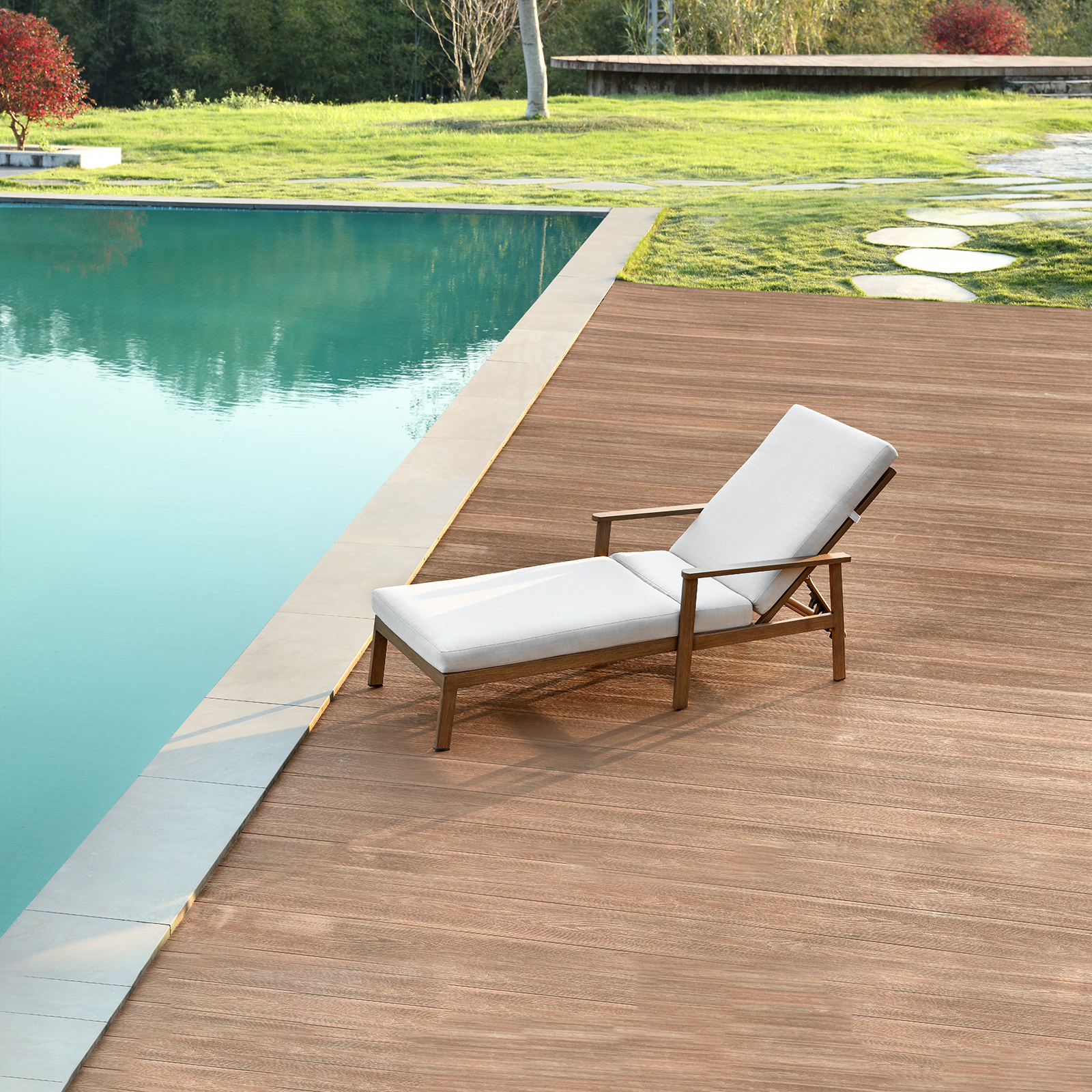 Outdoor wooden lounge chair with white cushion by poolside - Seehill