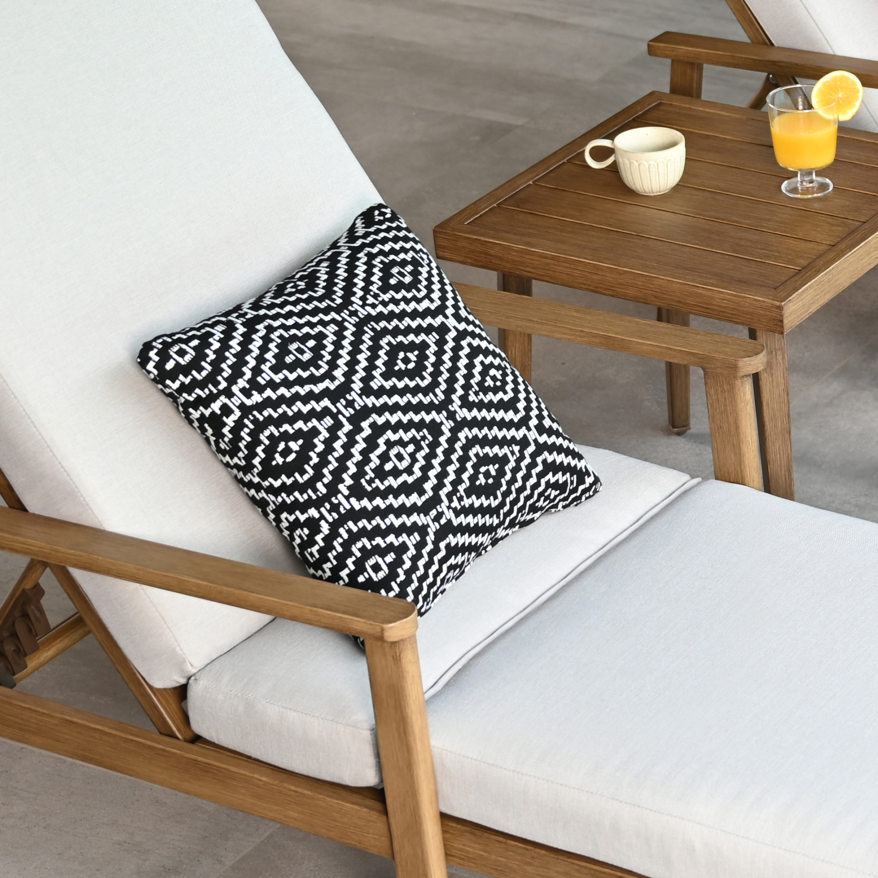 Highlighting the square weather-resistant outdoor throw pillow made from textured beige fabric. - Seehill