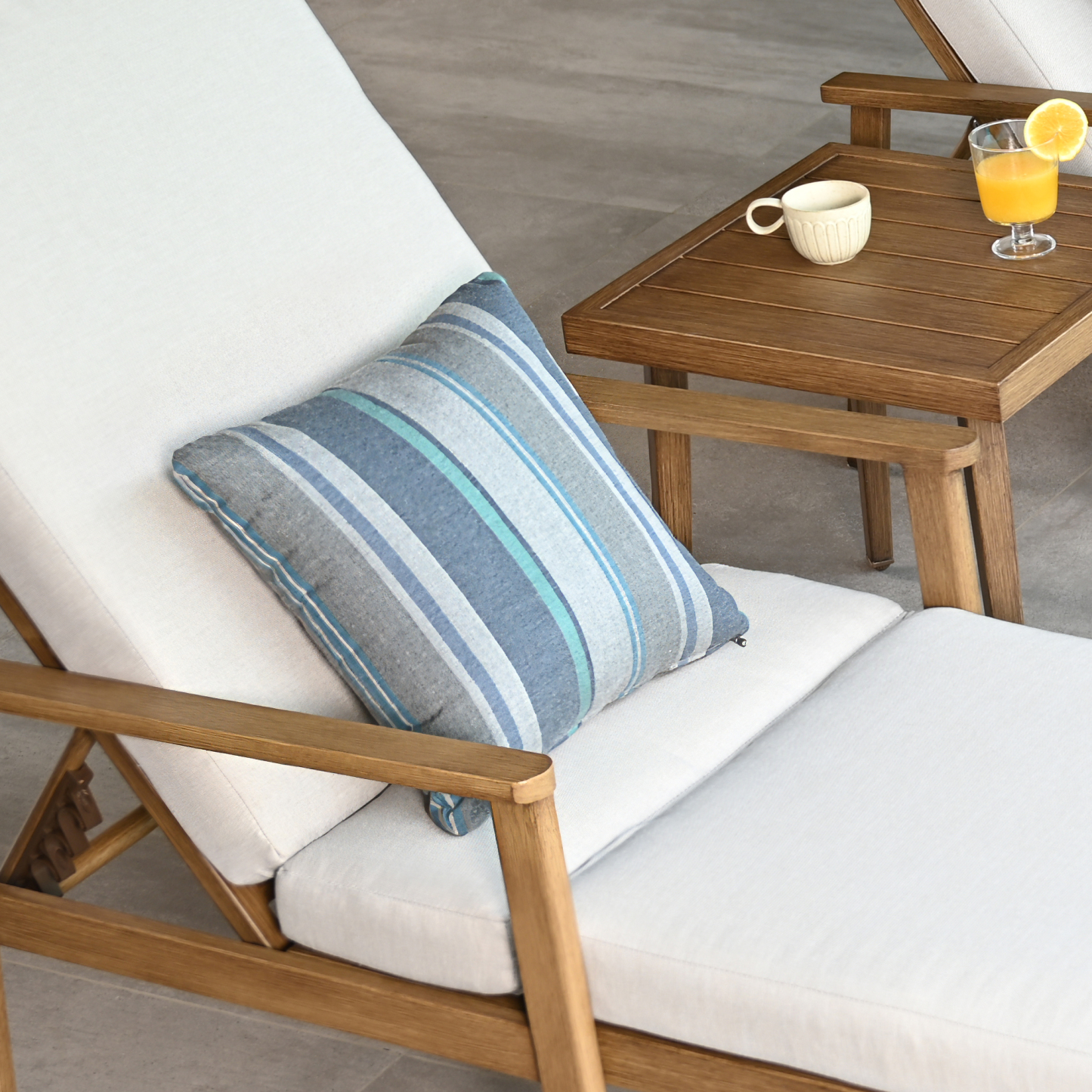 Crafted with a square weather-resistant outdoor throw pillow featuring blue and white geometric patterns. - Seehill