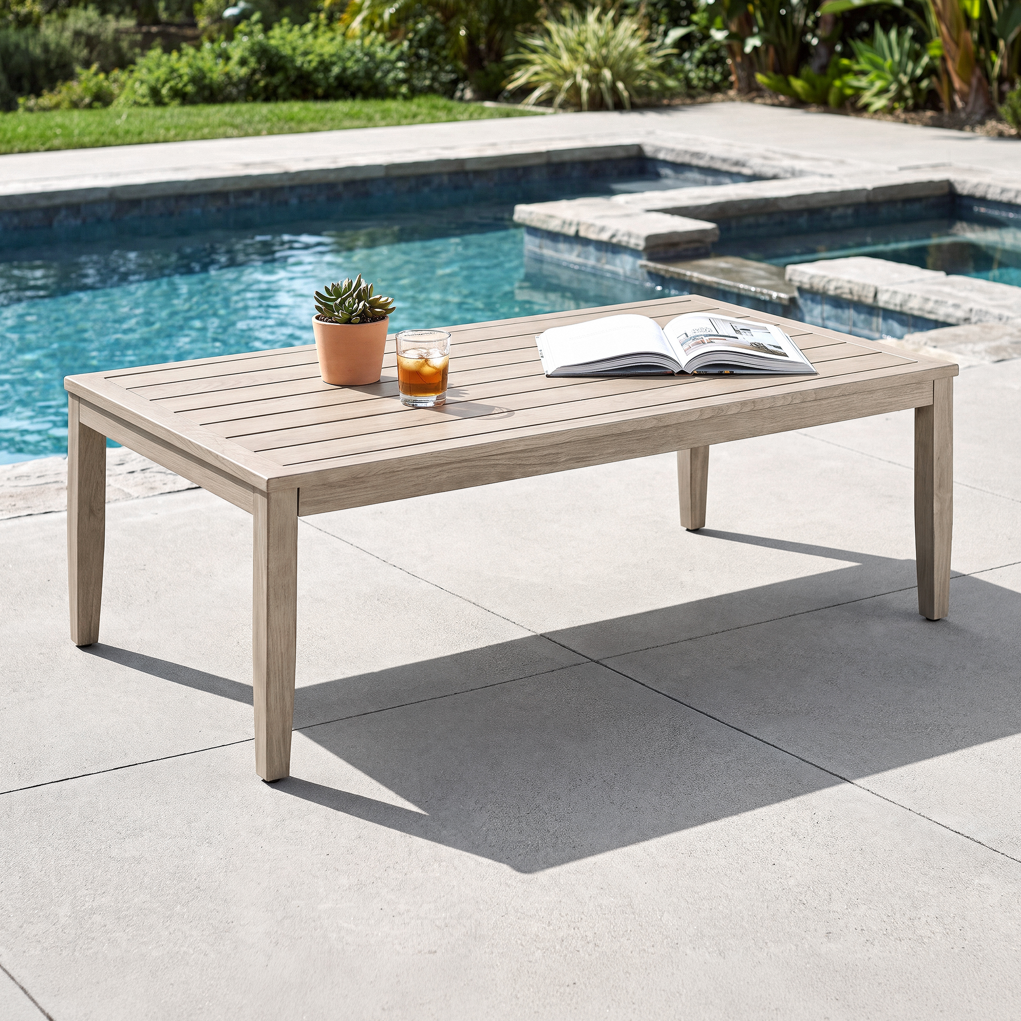 Outdoor patio coffee table with faux wood grain finish beside a clear blue pool-Seehill