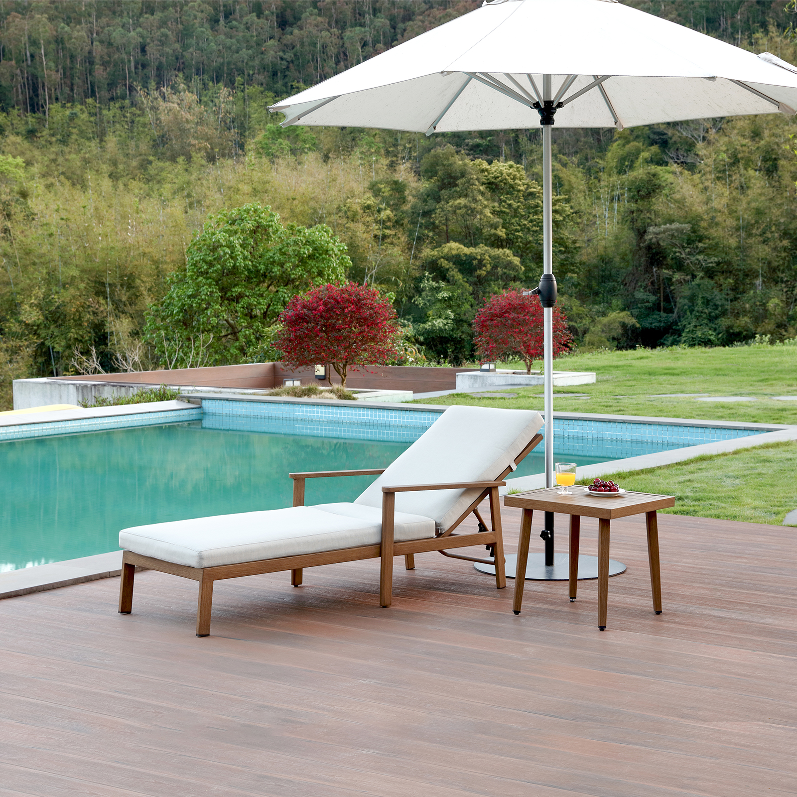 Wooden outdoor lounge chair with white cushion and side table near pool - Seehill