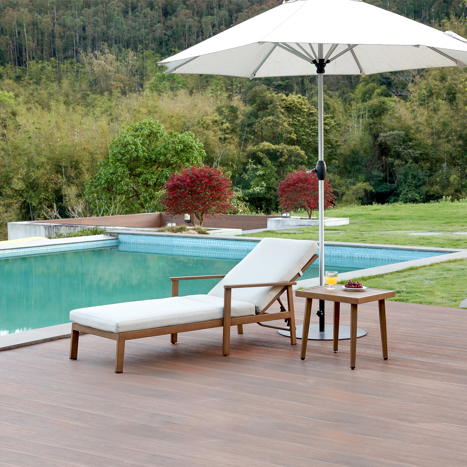 Wooden outdoor lounge chair with white cushion and side table near pool - Seehill