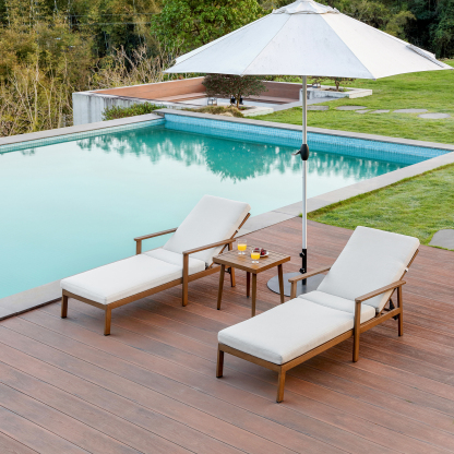 Wooden outdoor lounge chairs with white cushions and umbrella by pool - Seehill