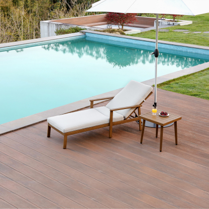 Teak lounge chair with cream cushion and side table by pool - Seehill