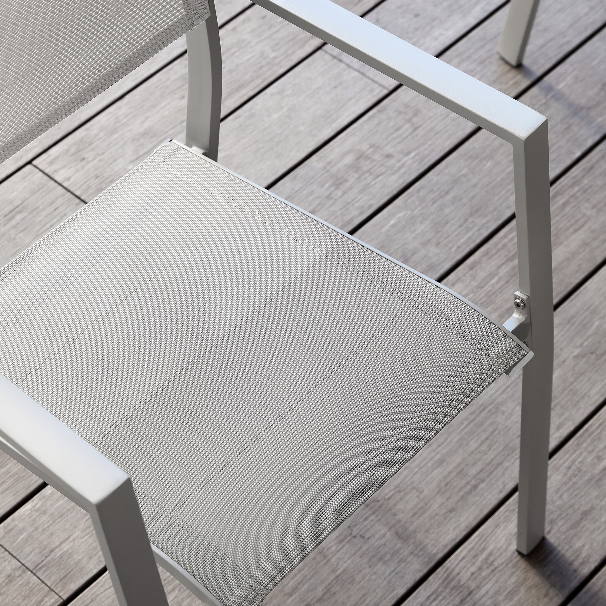 Explore the modern outdoor chair with mesh seat and armrests, white frame of the graceful piece. - Seehill