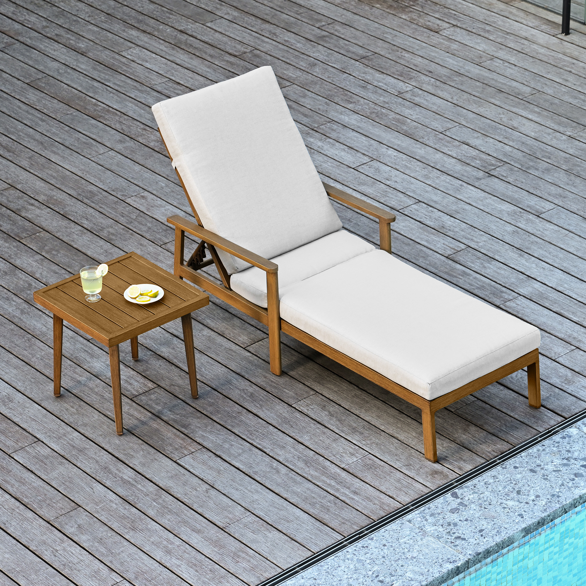 Outdoor lounge chair with thick white cushions and adjustable backrest by the poolside-Seehill