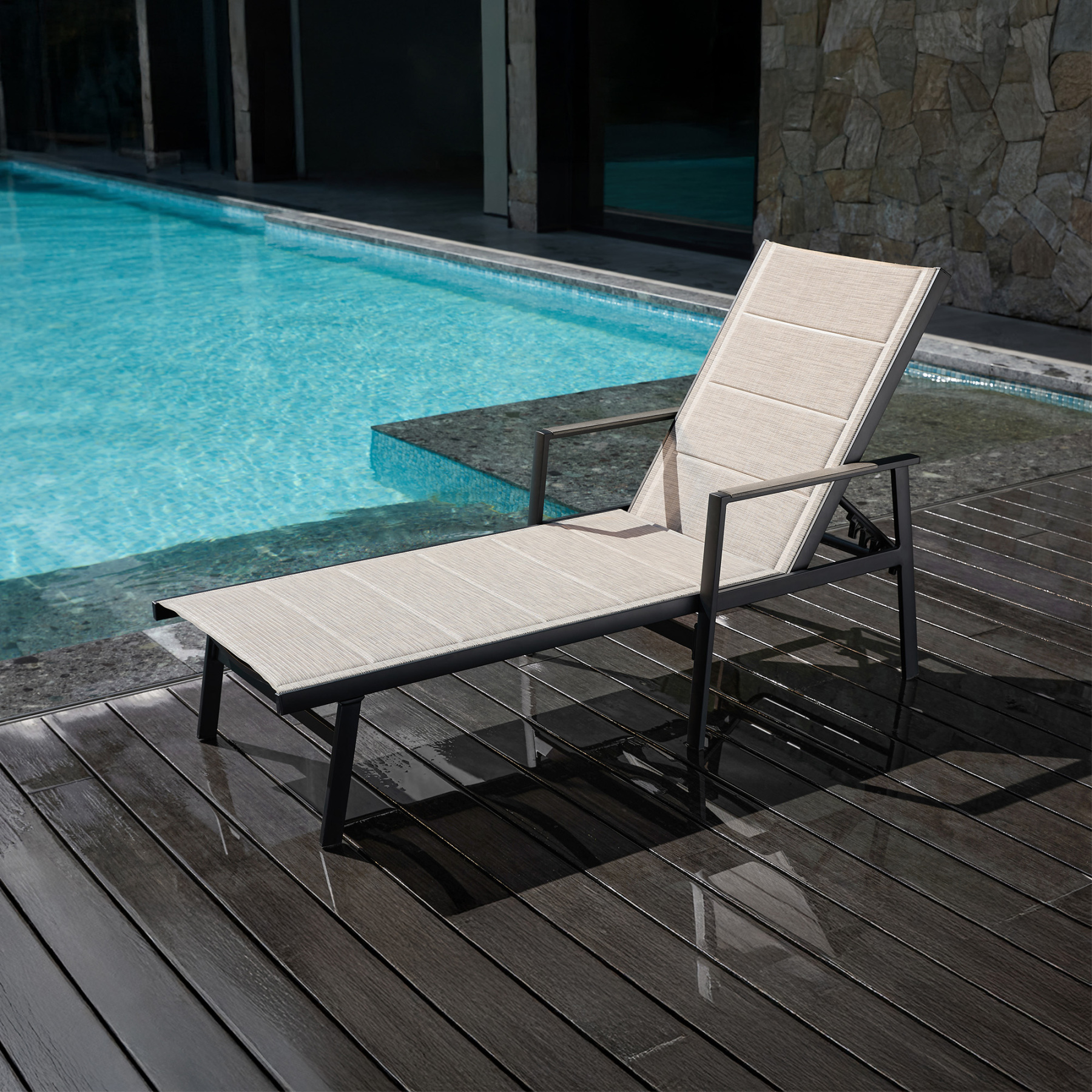 Outdoor lounge chair with beige fabric and black metal frame by pool - Seehill