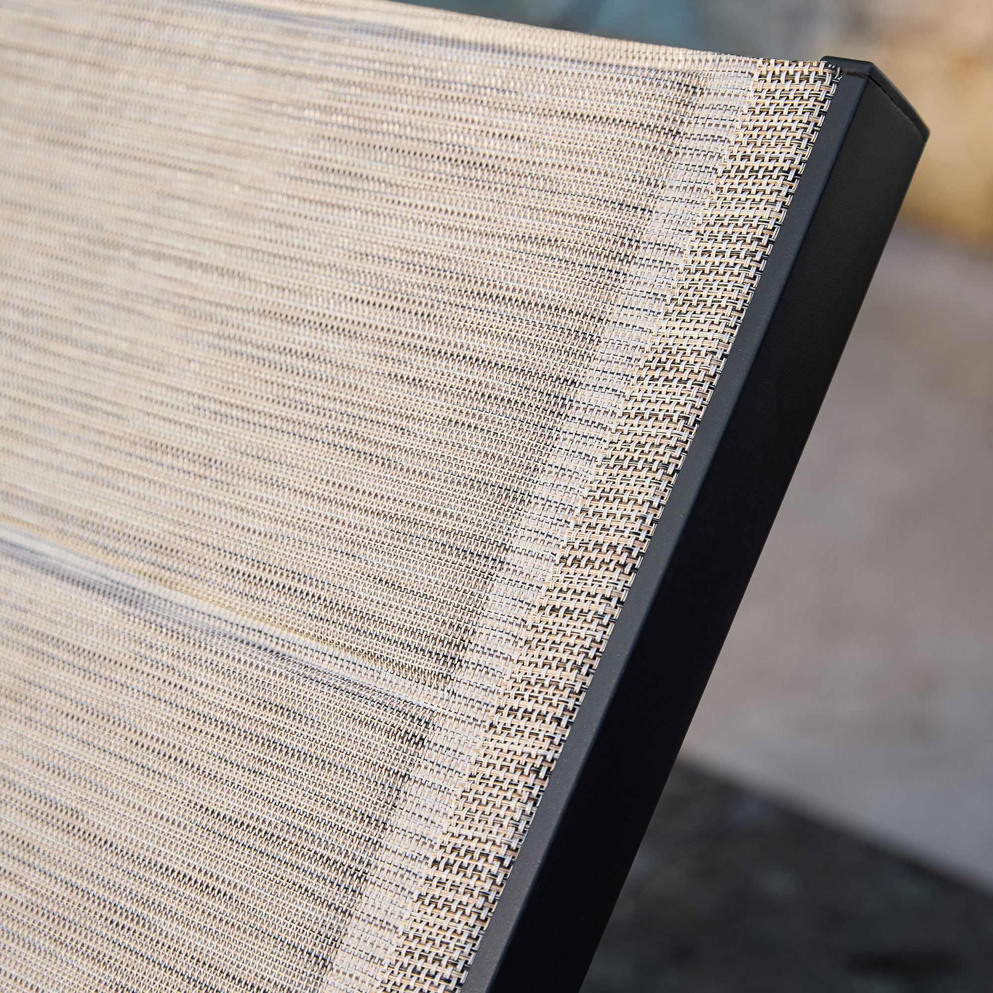Beige woven fabric outdoor chair with black frame close-up - Seehill