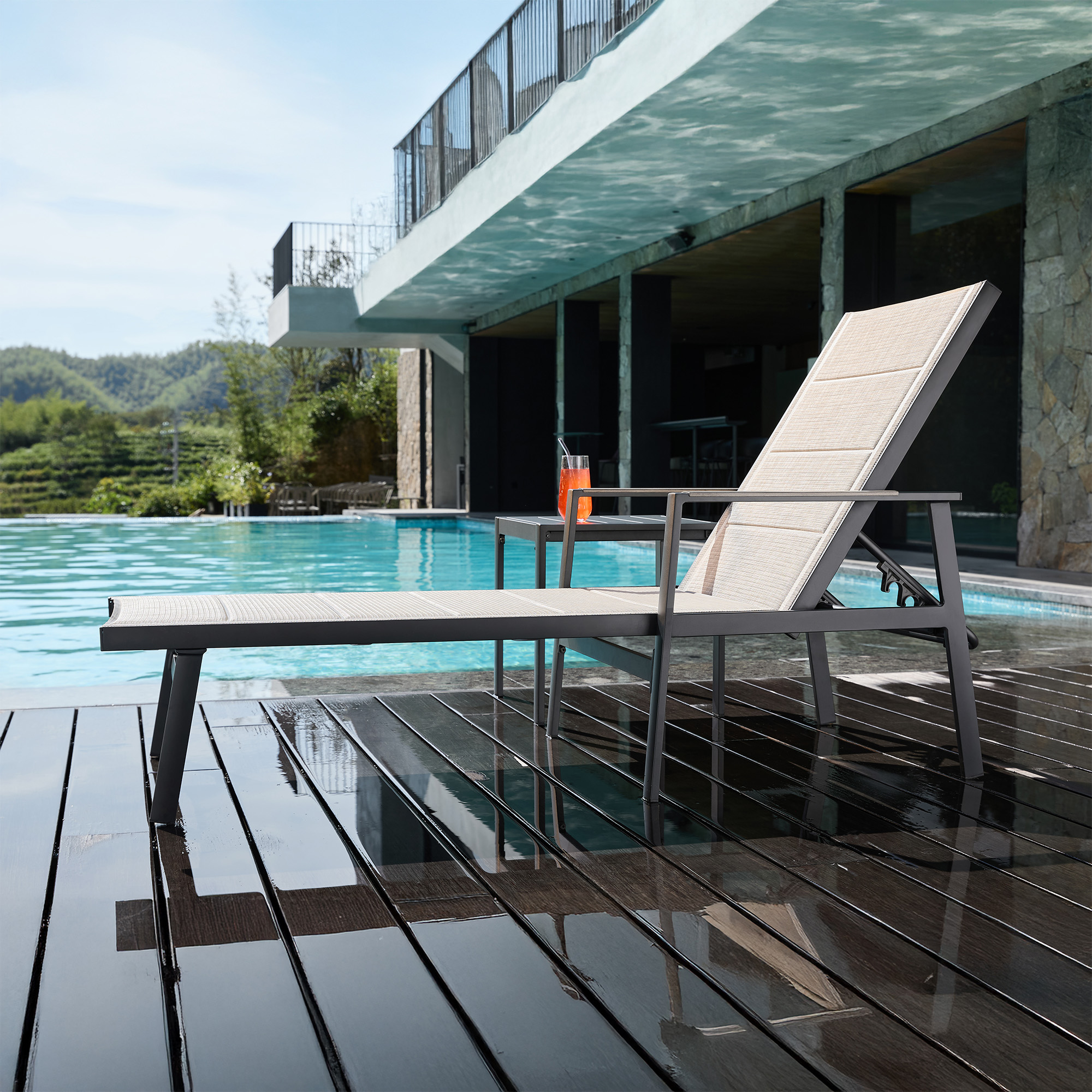 Highlighting the modern outdoor lounge chair with side table by the pool in this refined Outdoor Chaise Lounge set. - Seehill