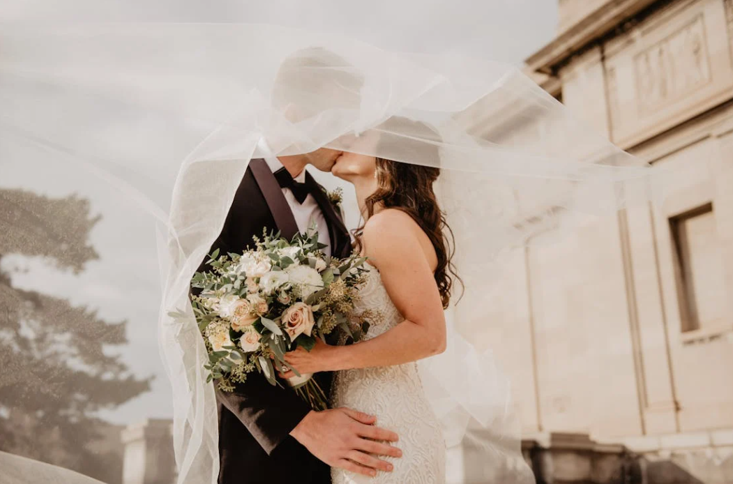 Cocosbride boho wedding dress bride and groom in suit sharing a romantic moment
