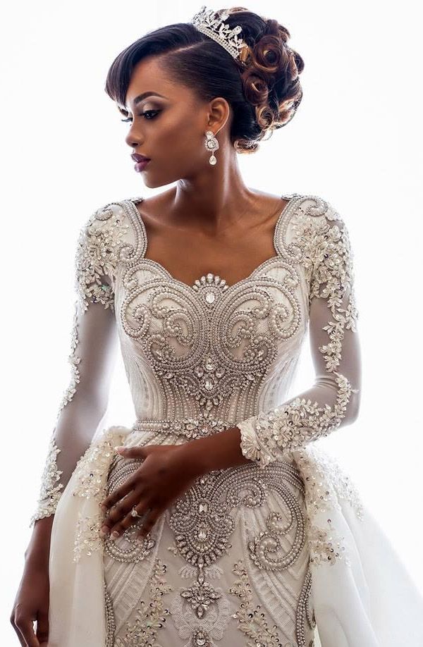 Mermaid wedding dress with beaded lace appliques, long sleeves and a full overskirt worn over the fitted base